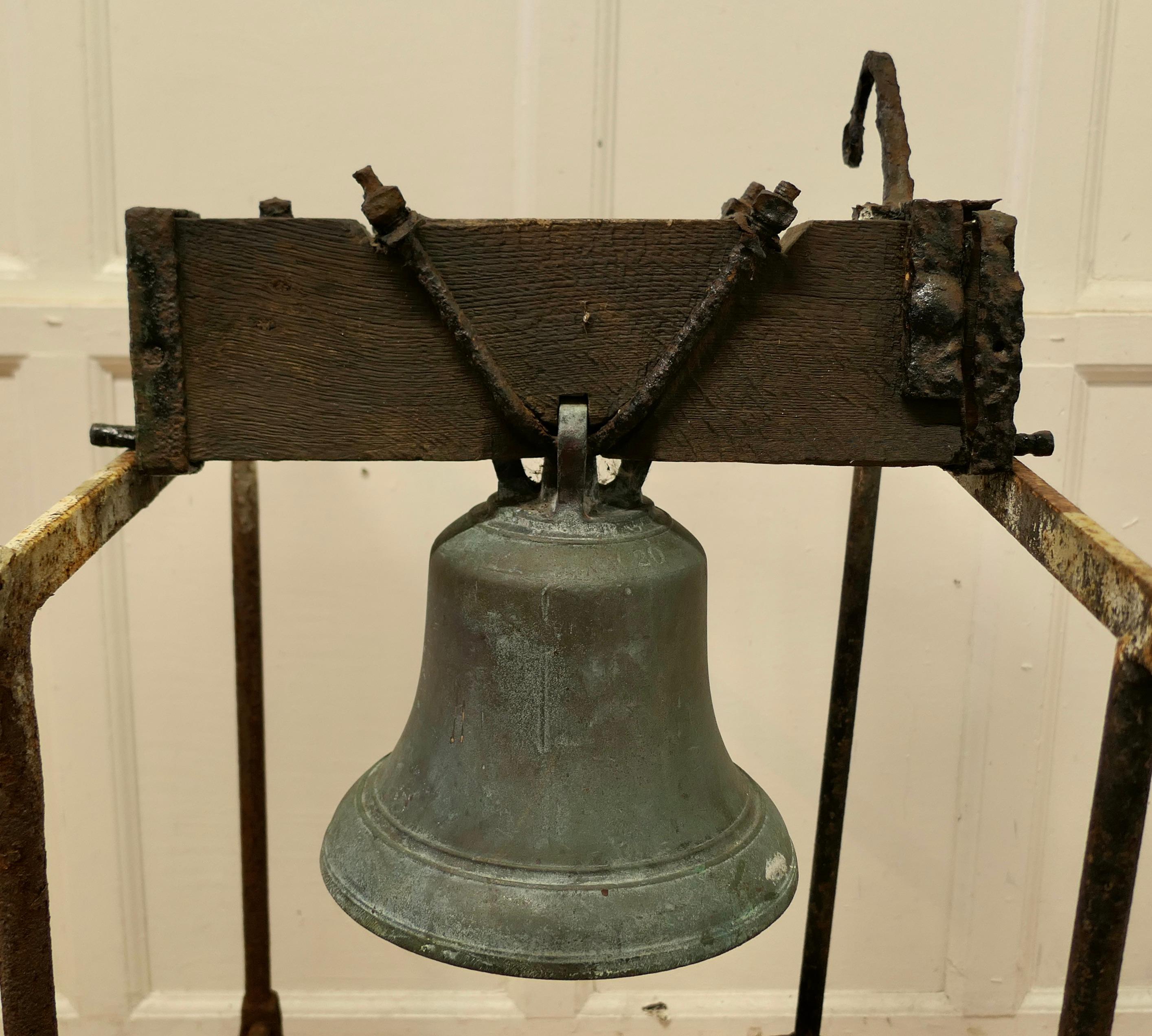 Heavy bronze bell, tower bell.

This is a very heavy piece it is on an Oak Yoke with iron fixings including a the bracket which holds the rope 
For the purpose of the pictures and to hear the ring it is hanging on a pair of Iron Trestles.
The
