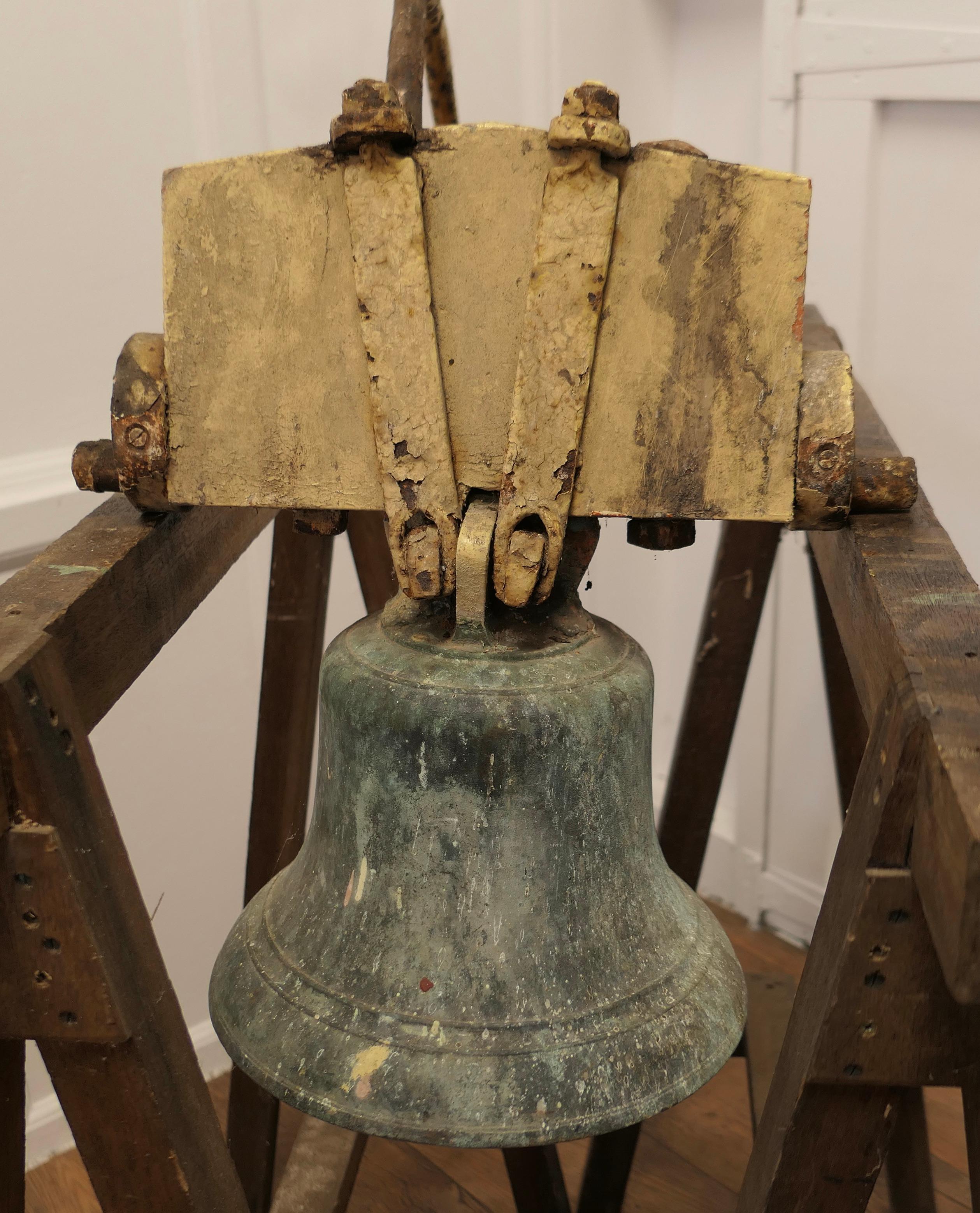 Heavy Bronze Bell, Tower Bell

This is a very heavy piece it is on an Oak Yoke with iron fixings including a the bracket which holds the rope 
For the purpose of the pictures and to hear the ring it is hanging on a pair of Trestles
Sound no