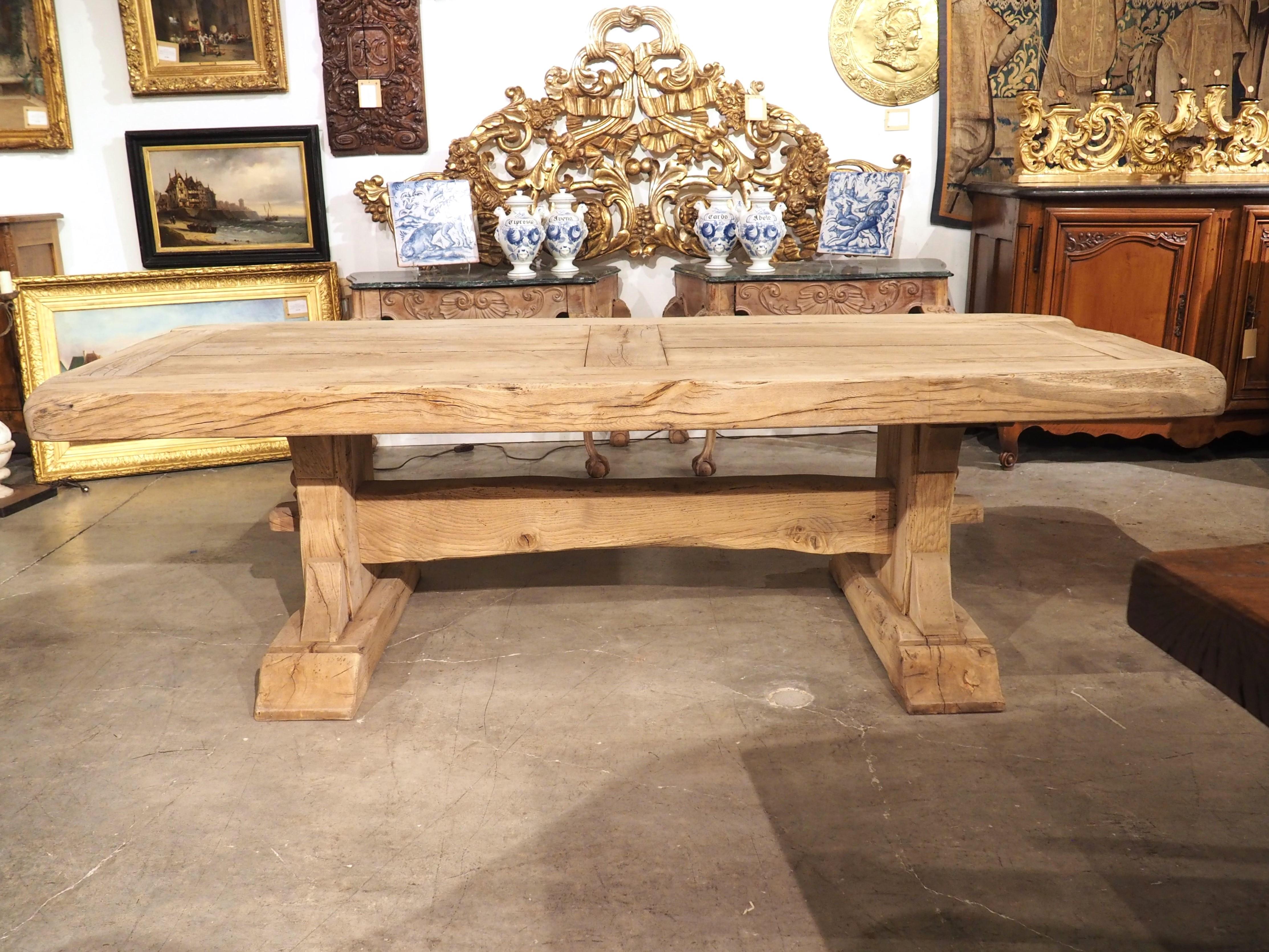 Reminiscent of the robust dining tables used by monks during the Middle Ages, this oak monastery table was hand-carved from oak in France, circa 1950. Our magnificent table exudes character, boasting a substantial four-inch thick top, with