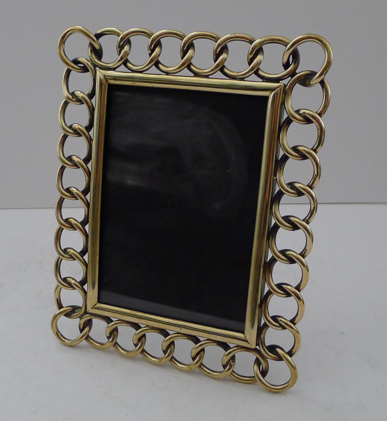 A good sized late Victorian picture frame created from a series of heavily cast intertwined rings, know as a 