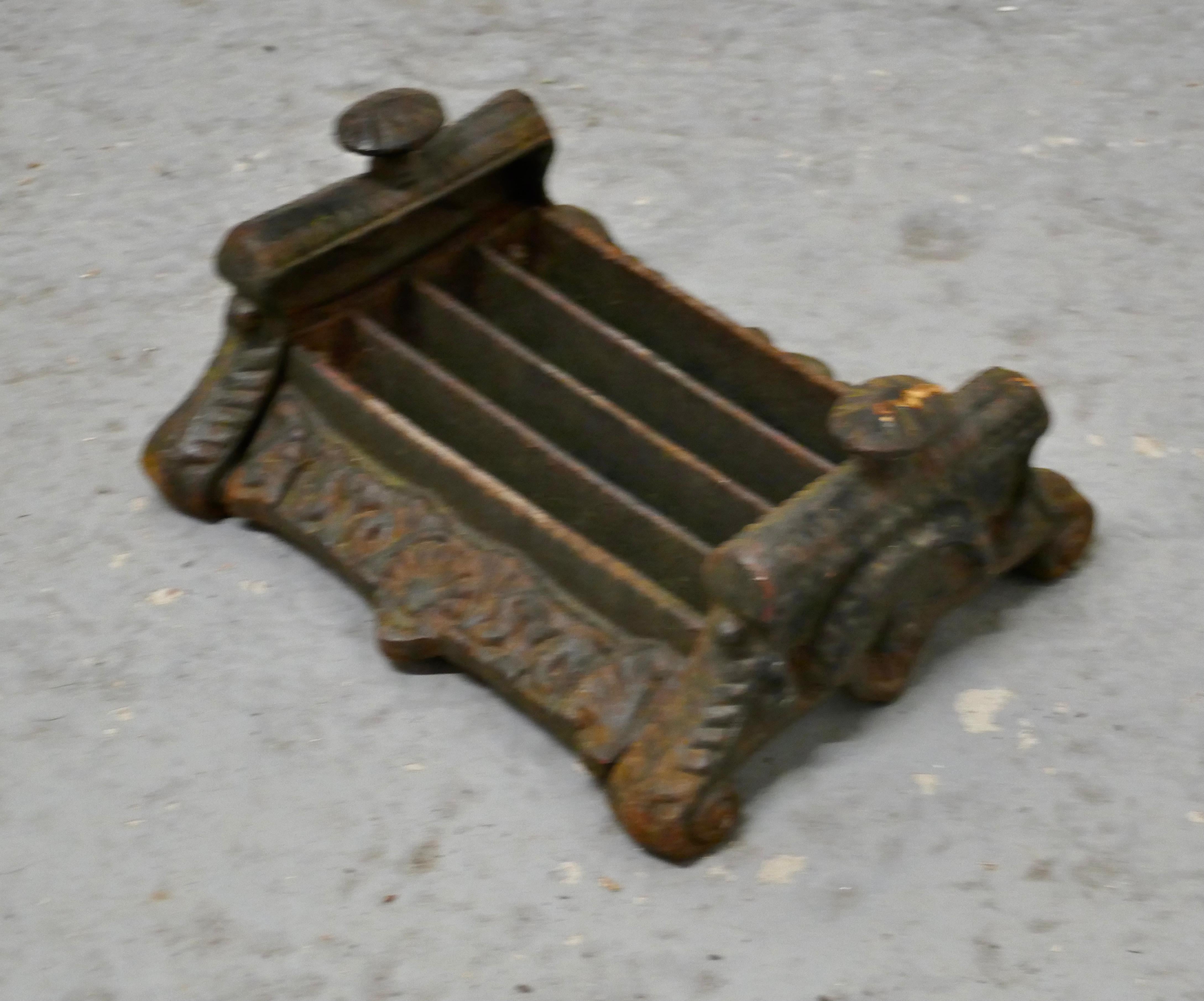 Heavy cast iron Victorian boot scraper.

This is a very old piece, it is made in iron as you would expect it is heavy, the scraper has 5 scraping bars set between decorative sides
It has been well used but still has very many years life left in