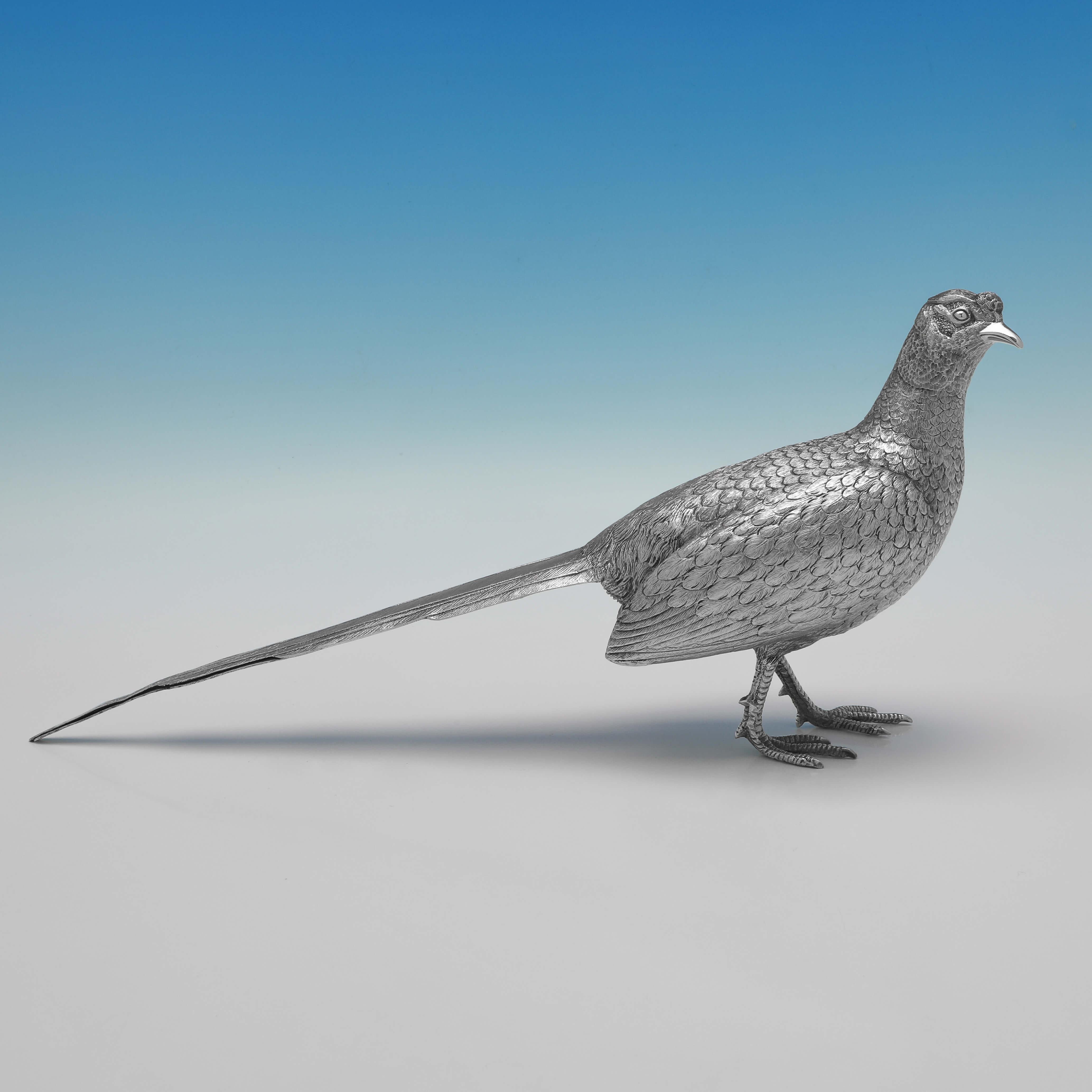 Hallmarked in London in 1967 by Richard Comyns, this handsome, pair of Sterling Silver Pheasants, are realistically cast and hand finished. 

The male measures 6.25