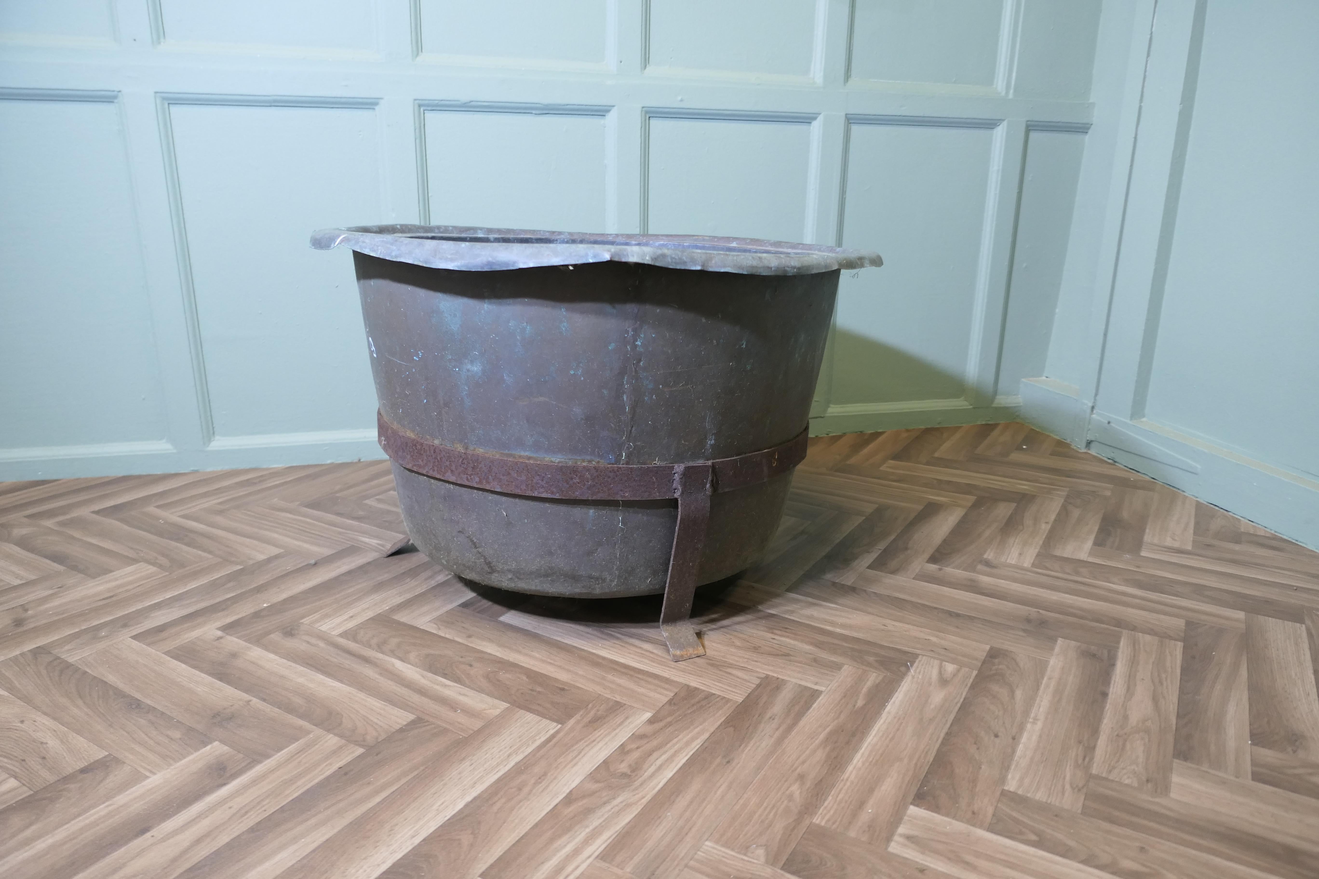Heavy Copper and Wrought Iron Log Bin  

This is a very good heavy copper piece, it is made in hand beaten copper, and set in a wrought iron carrier with riveted banding
The Copper would work well as a log basket or as a planter for a large