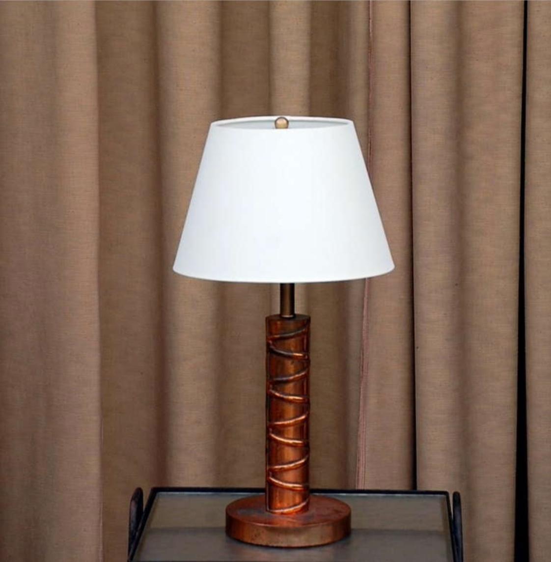 Heavy copper table lamp with custom linen shade.