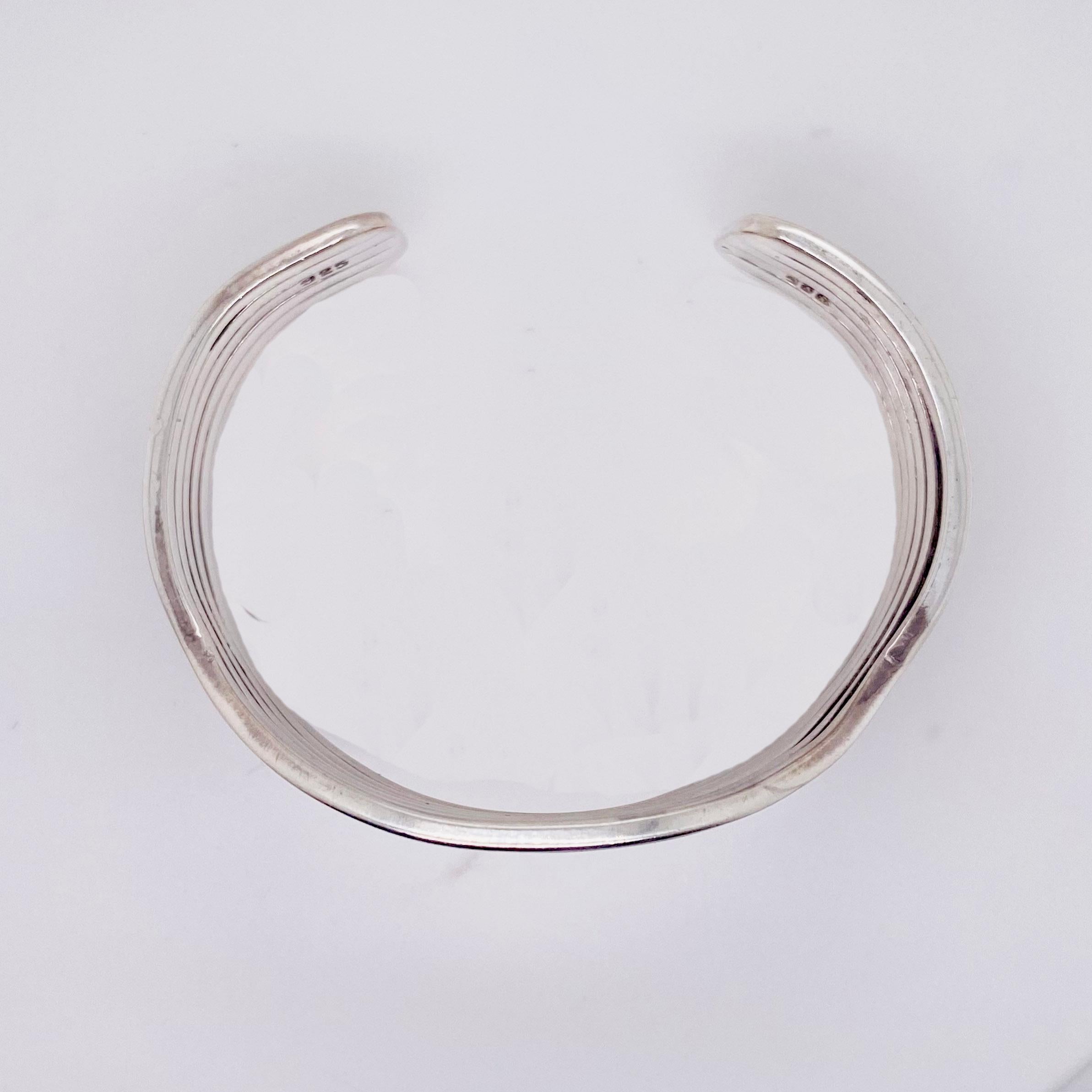 This bracelet was made in our shop by our jewelers.  The bracelet is well-made and nice and thick so that it will never break! The curve in the bracelet is so lovely and looks great on your wrist!  
Bracelet Type: Cuff
Metal Quality: Sterling