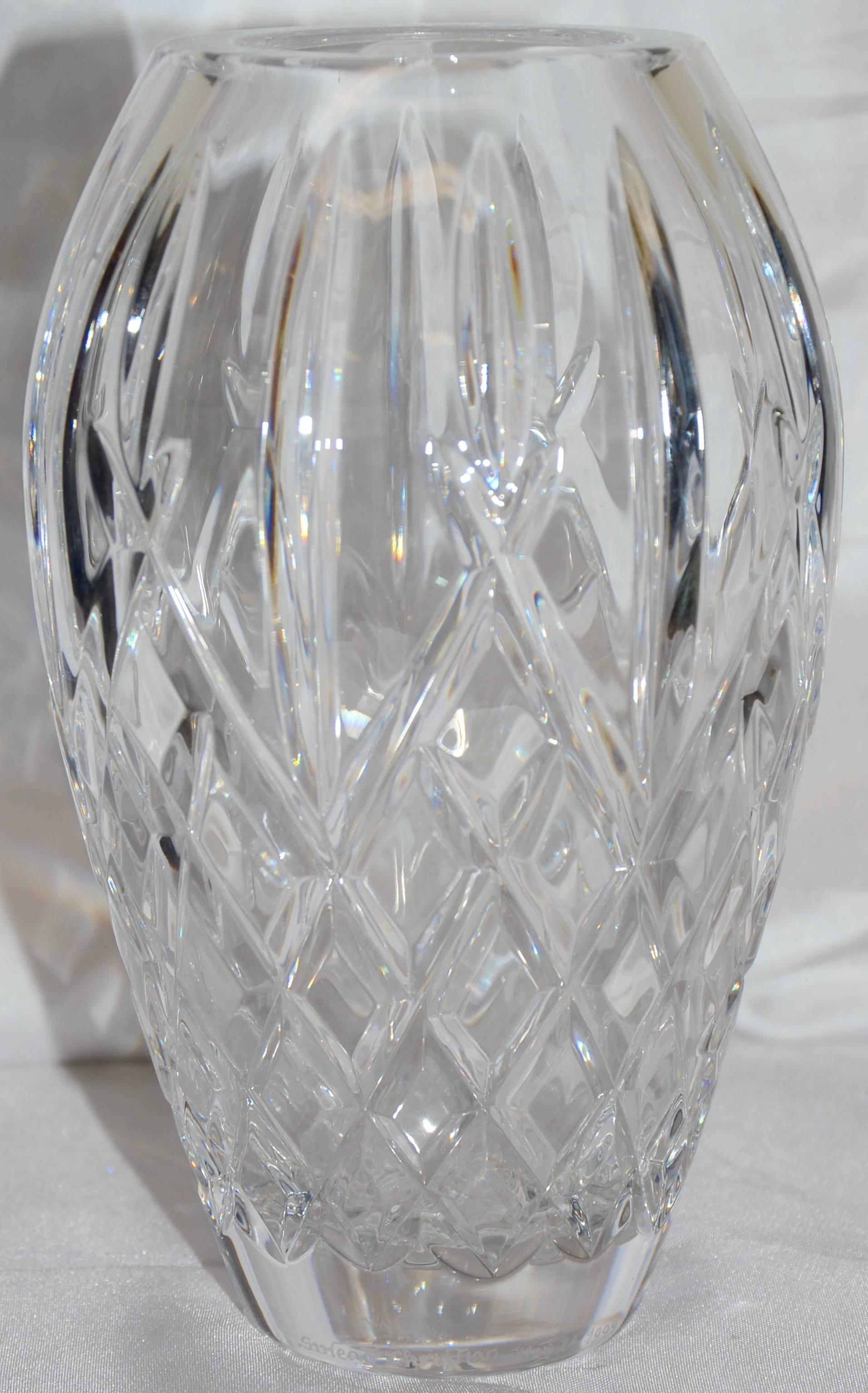The Waterford mark stands for quality and you will find that in this diamond pattern, heavy crystal vase. The edges are polished smooth and you can feel the quality of the glass. It is signed by Sinead Christian and dated May 24, 1999.