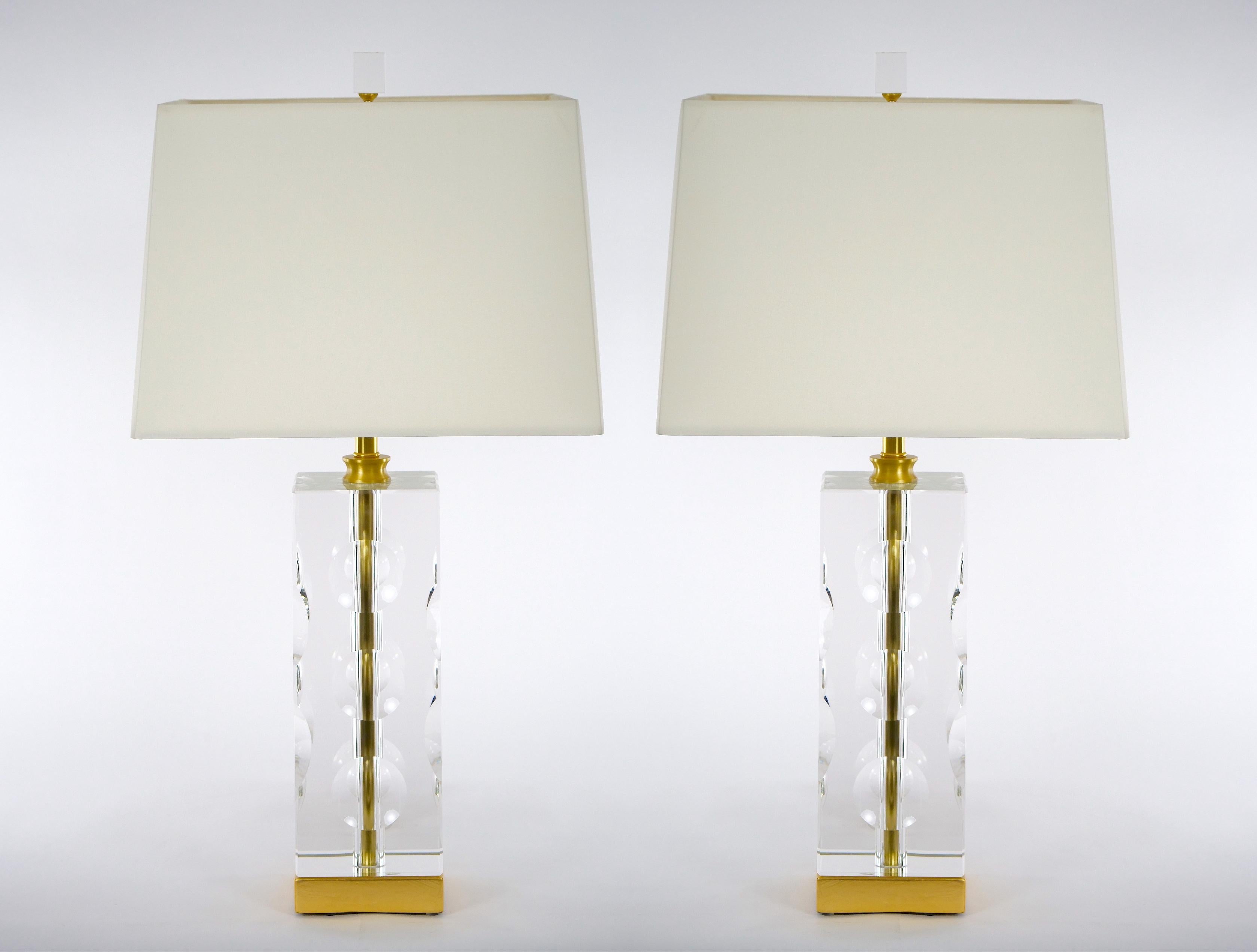 Late 20th century heavy cut glass Venetian hand cut and brass decorated details pair table lamps. Each lamp features a very deep hand cut crystal in an architectural squared column shape resting on a gilt gold base. Each lamp is in great working