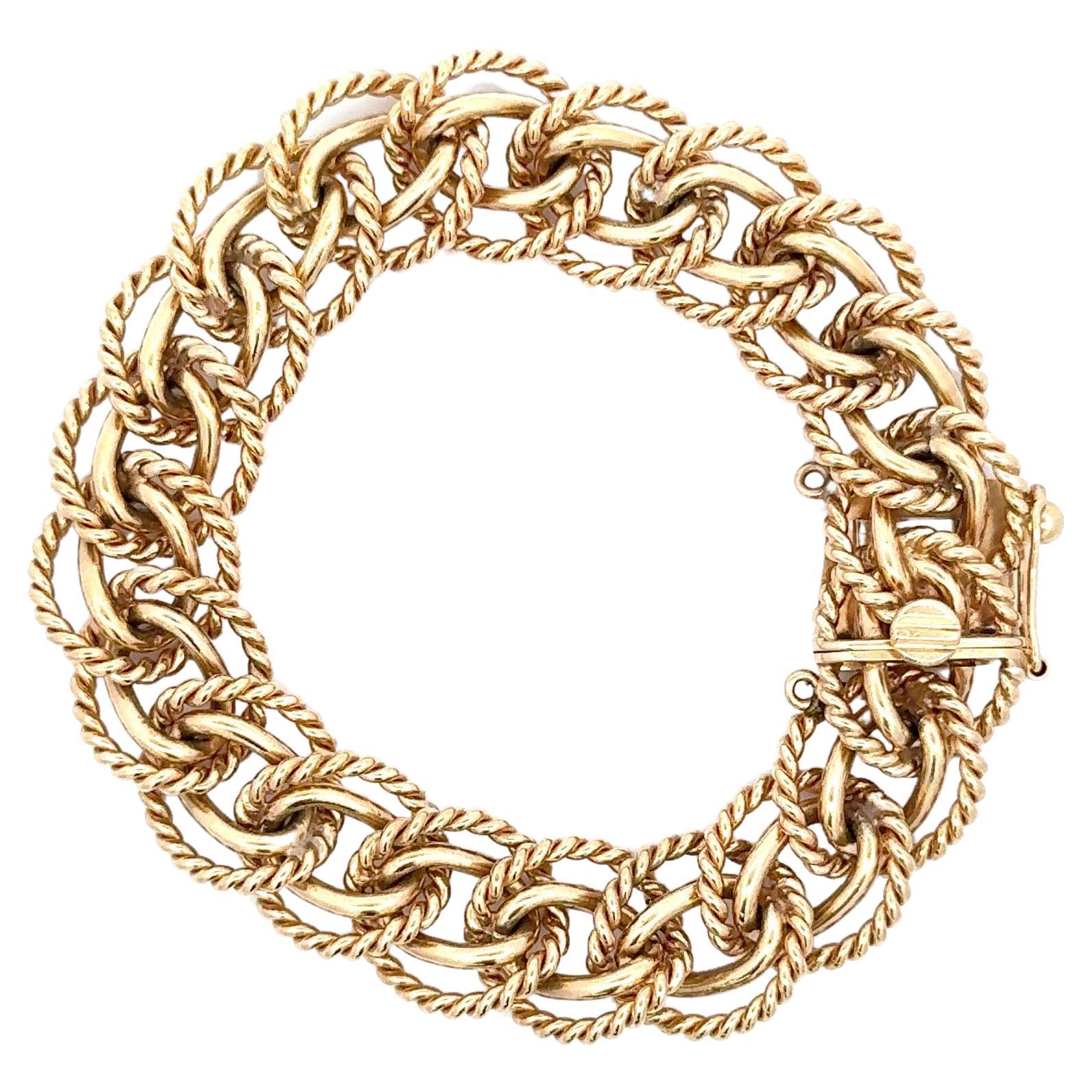 This double row bracelet features two rows of a twist and high polish links weighing 68.6 grams, in 14 karat yellow gold. 
7.75 inches