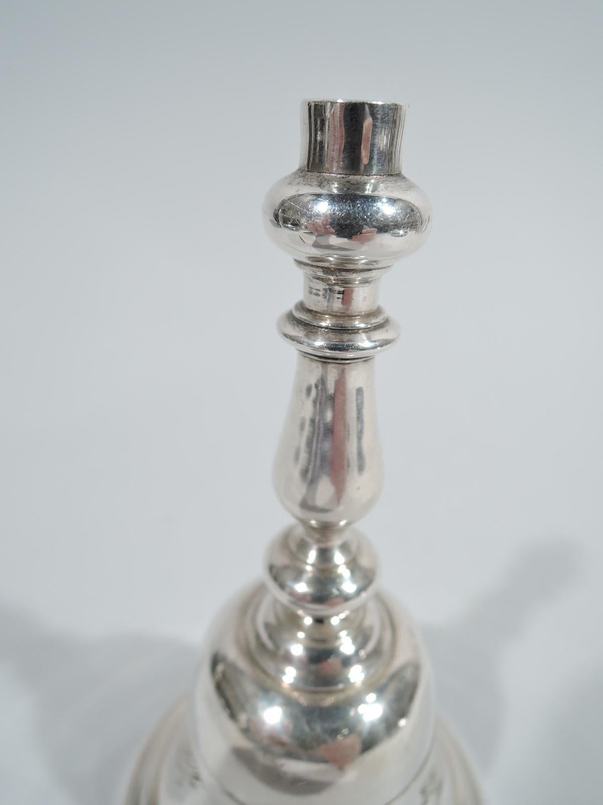 George V sterling silver bell. Made by Charles & Richard Comyns in London in 1925. Stepped and spread bowl and knopped baluster handle. Melodious ting-a-ling. Fully marked. Heavy weight: 12 troy ounces.