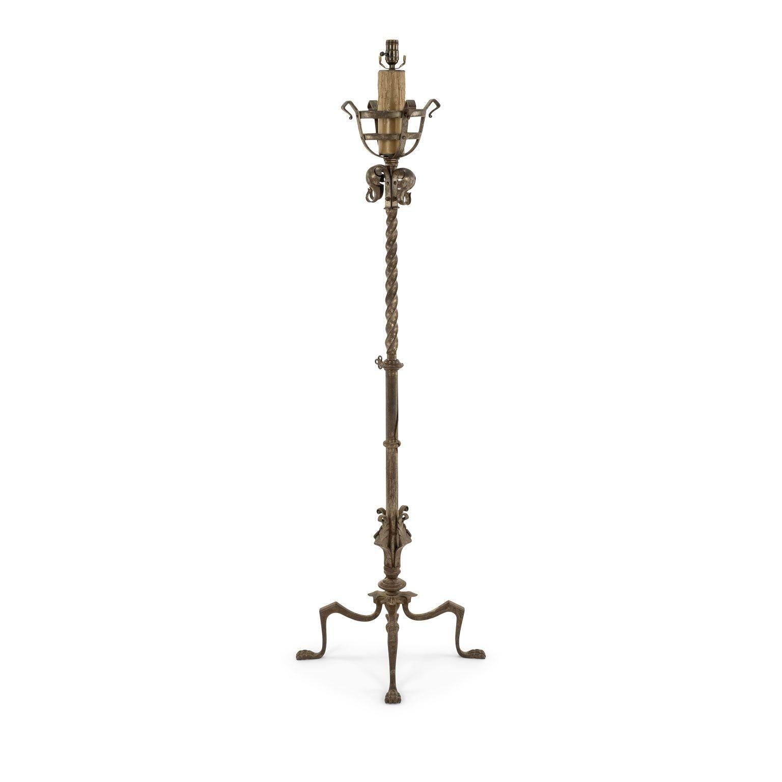 Heavy, fine forged-iron floor lamp created in Spain circa 1900-1940. Four-legged base with paw feet. Wired for use within the USA. Sold without a shade.