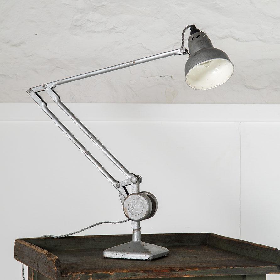 An original Admel architects desk lamp, featuring a large counterweight design.
Original paint and colour in an industrial silver with wear and patina consistent with its age. The lamp shade is enamel lined.
British Made, England, 1950s
A good