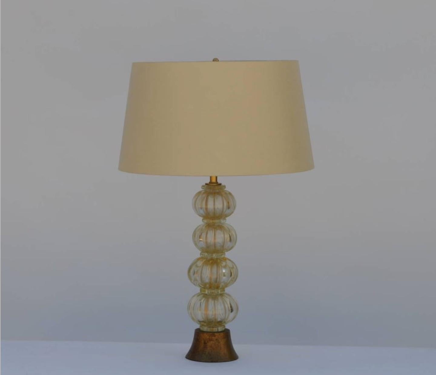 Heavy gilt Murano glass stem lamp with custom silk shade in the style of Barovier. Giltwood base. Restored and rewired with gold twist cord.

Custom shade dimensions: upper edge 16 inches, lower edge 19 inches, height 10.5 inches. Overall lamp