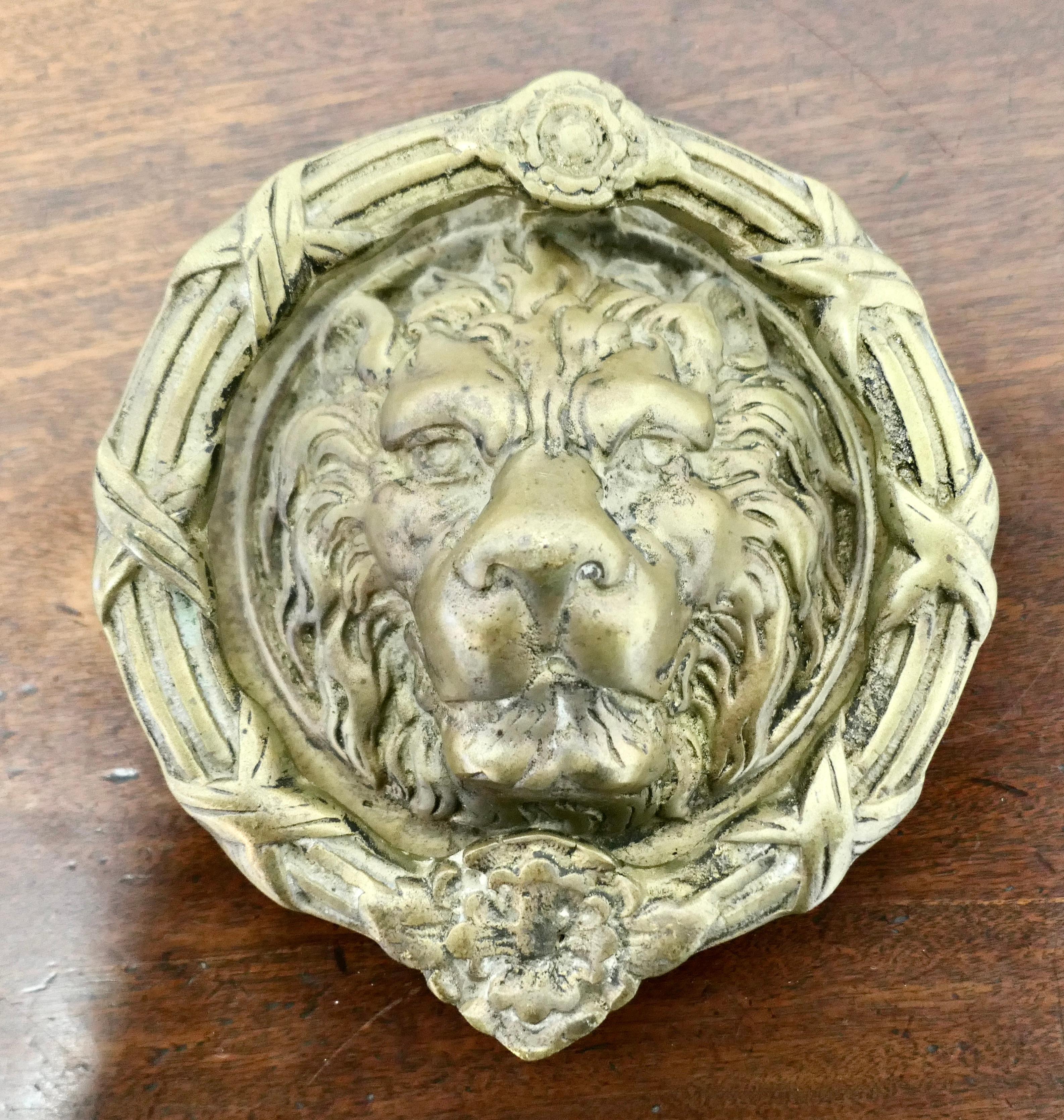 Heavy Gothic Lion’s Mask Brass Door Knocker 

This is a superb door knocker, the handsome Lion’s Head is  at the centre  and the heavy outer ring lifts and lands on the striking plate 
The door knocker is in good condition it measures 9” in diameter