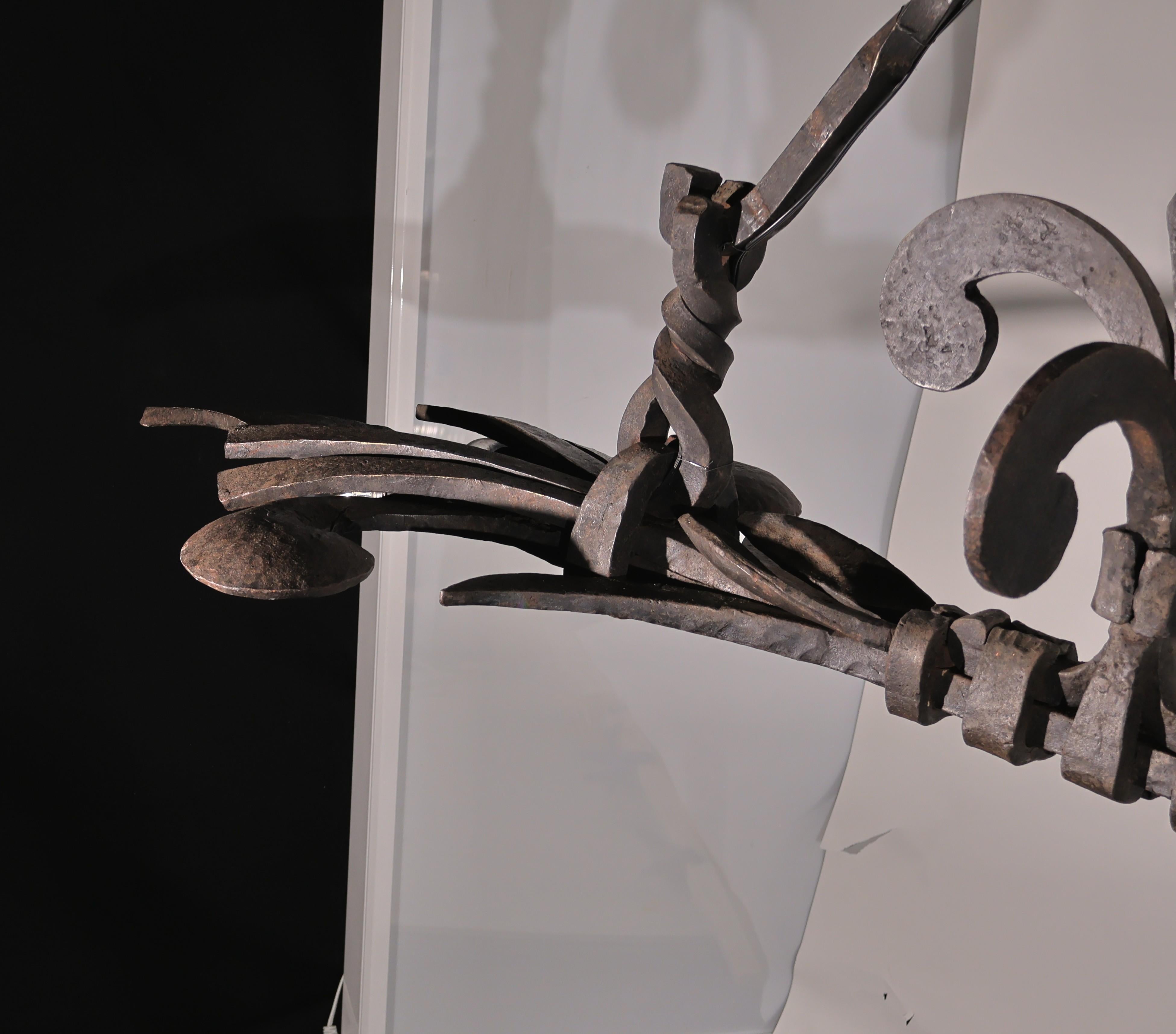 A Magnificent Iron Chandelier. Extraordinary iron work. Ideal for a kitchen island. France, circa 1890. 4 lights.
Dimensions: Height 31