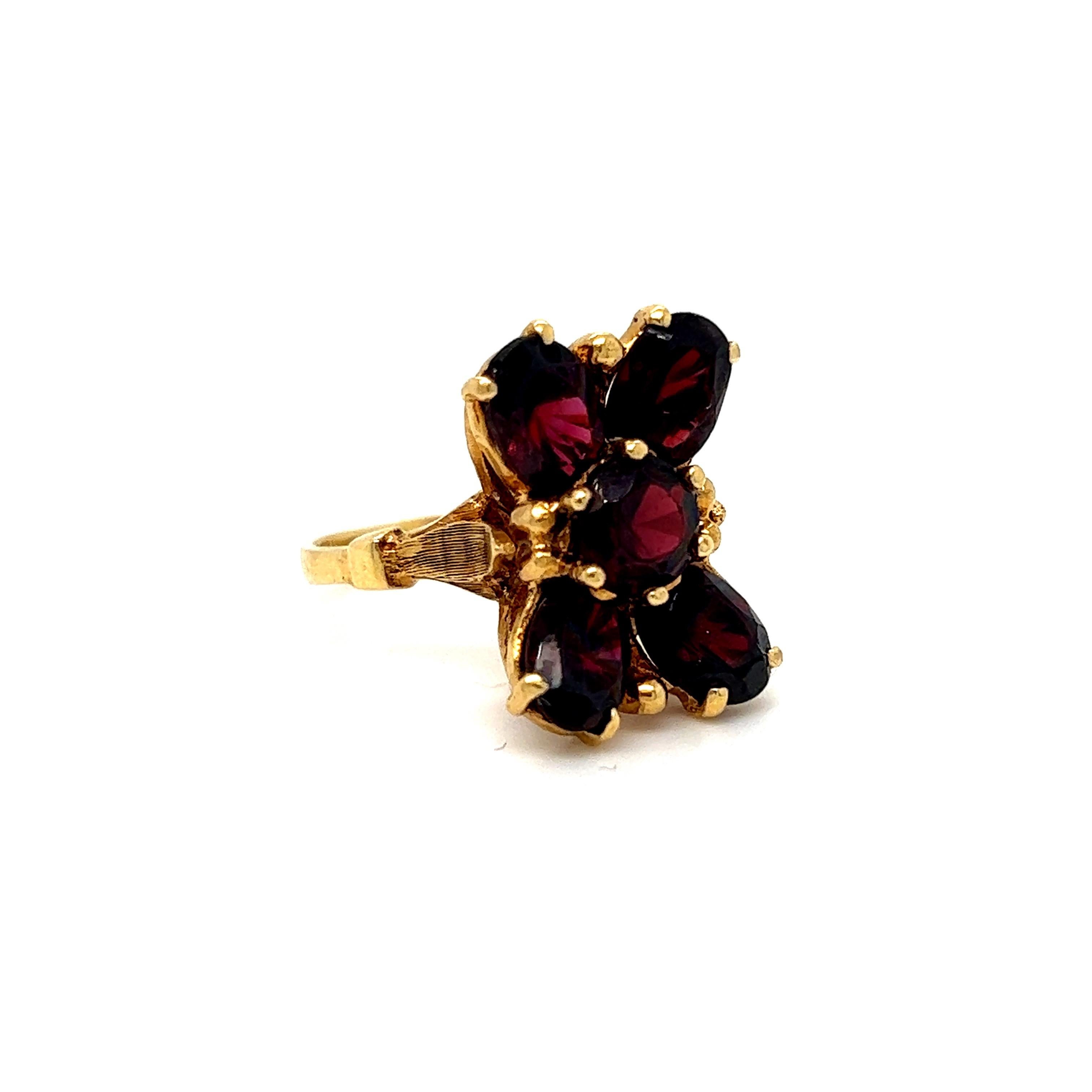 What a gorgeous ring this Heavy Antique Garnet Ring is! I just LOVE it! Crafted in 18K Yellow Gold, the design features a beautiful flower of unique Garnets. The garnets are both Oval and Round Cut, total approximately 4.00ct, and are of fine