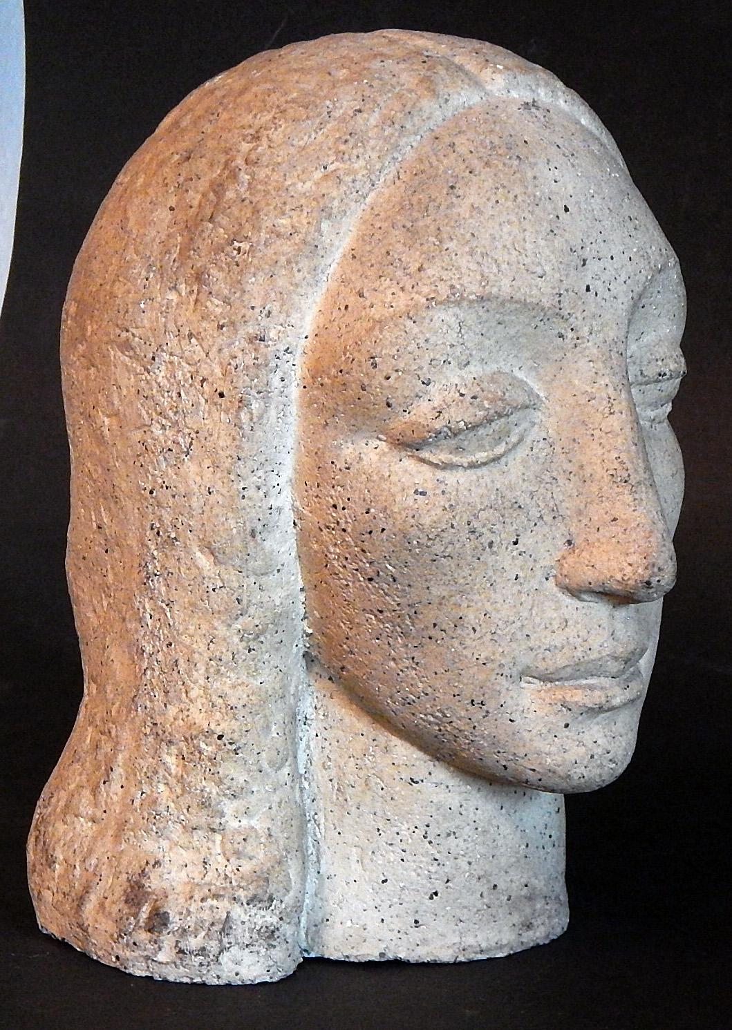 Clearly influenced by stylized Etruscan and African sculpture, this heavy-lidded female head is a classic example of Art Deco design. The artist was Jean de Marco, who was born in France, studied at the Ecole Nationale des Arts Decoratifs, and later