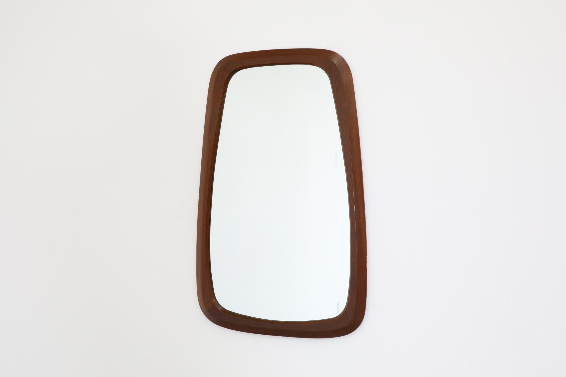 Dieser dänische Mid-Century-Spiegel aus Teakholz aus den 1960er Jahren wurde von der Arbeit des schwedischen Mid-Century-Herstellers Ateljé Glas & Trä inspiriert. Es handelt sich um einen schönen, organisch geformten Rahmen, der für die Aufhängung