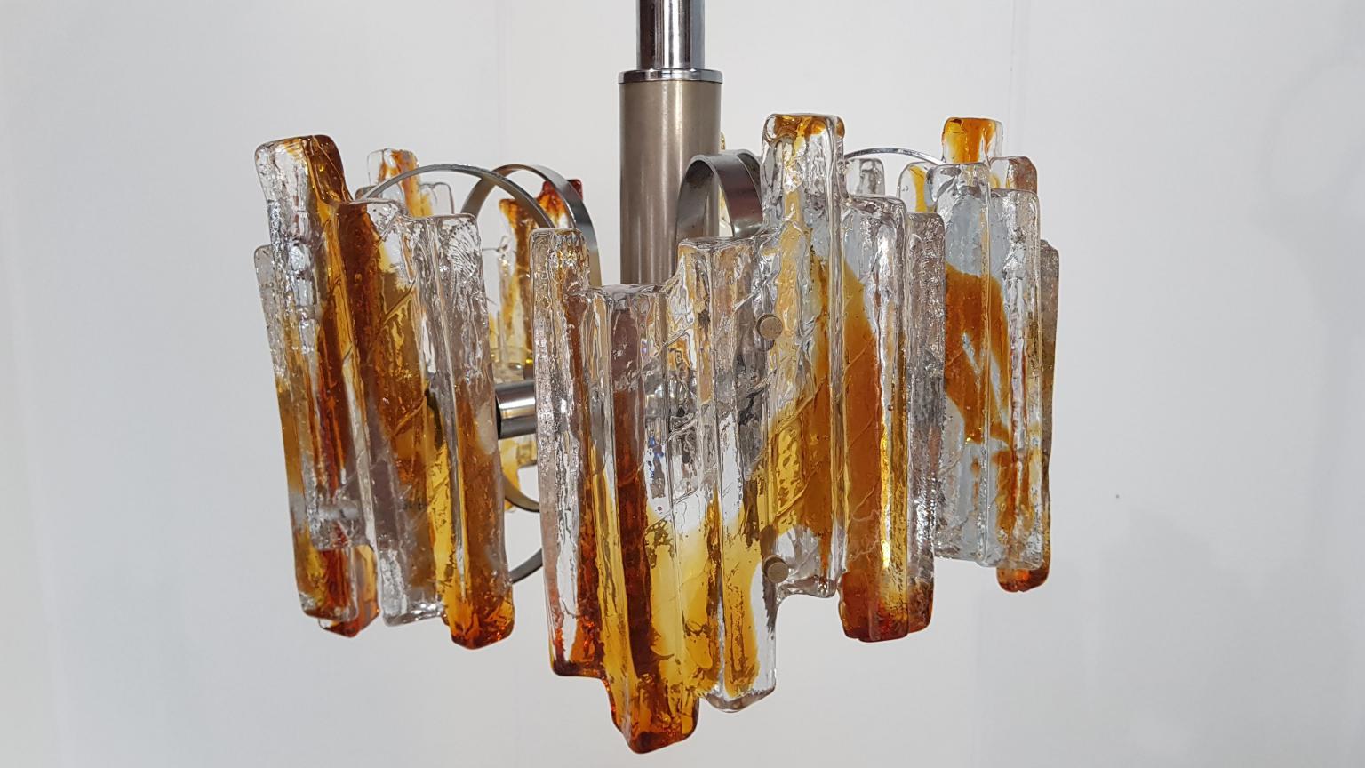 Heavy Murano chandelier, Italy, 1970s.

Beautiful metal chandelier with heavy amber colored Murano glass elements.

Lamp is suitable for 220v. But because of the lower voltage in the USA and some other countries it can be used in those countries