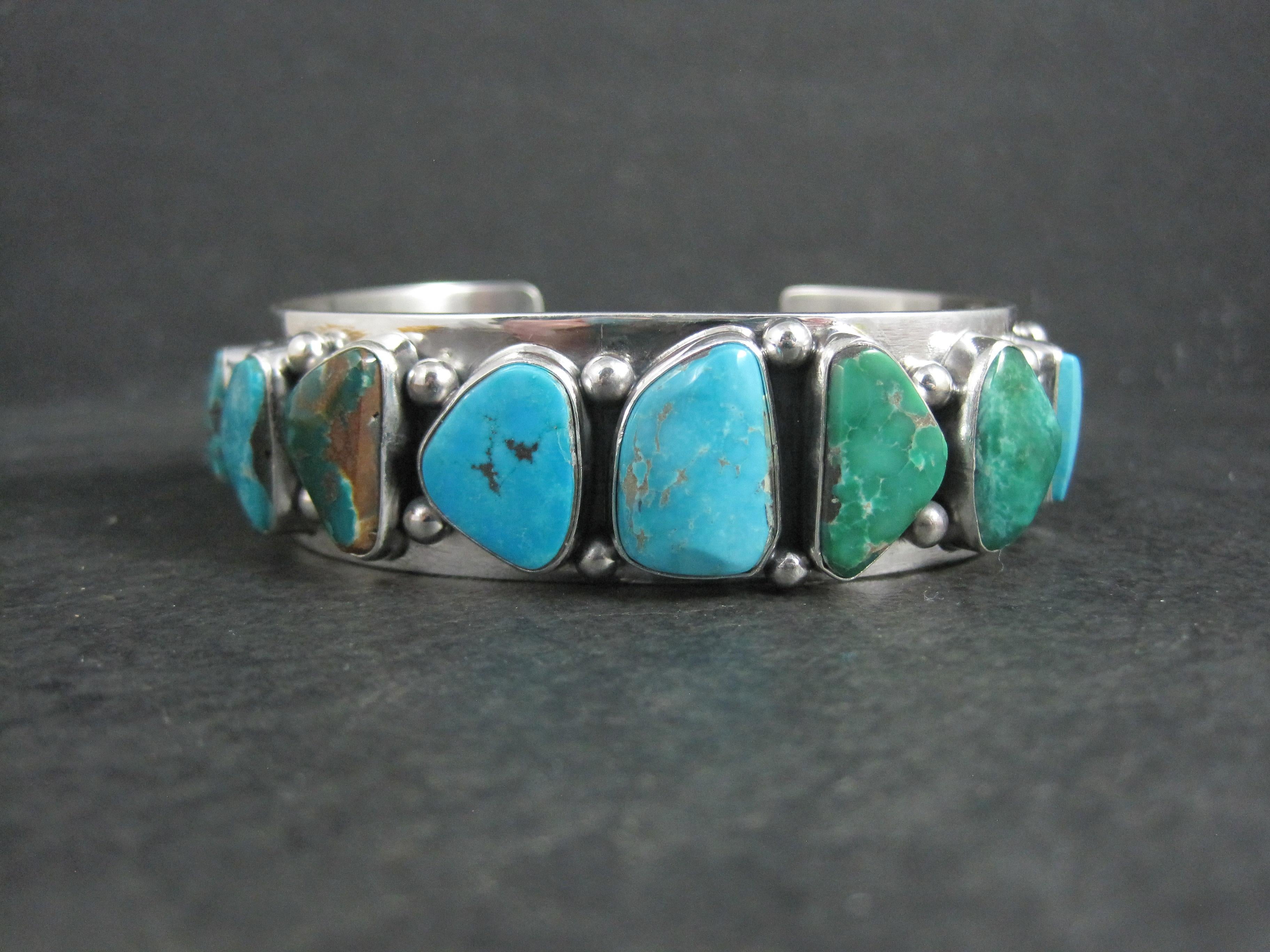 This stunning cuff bracelet is a creation from Navajo silversmith Mark Yazzie.
It is sterling silver with 12 natural turquoise gemstones from 7 different mines.
This bracelet measures 3/4 of an inch wide. It has an inner circumference of 6 1/2