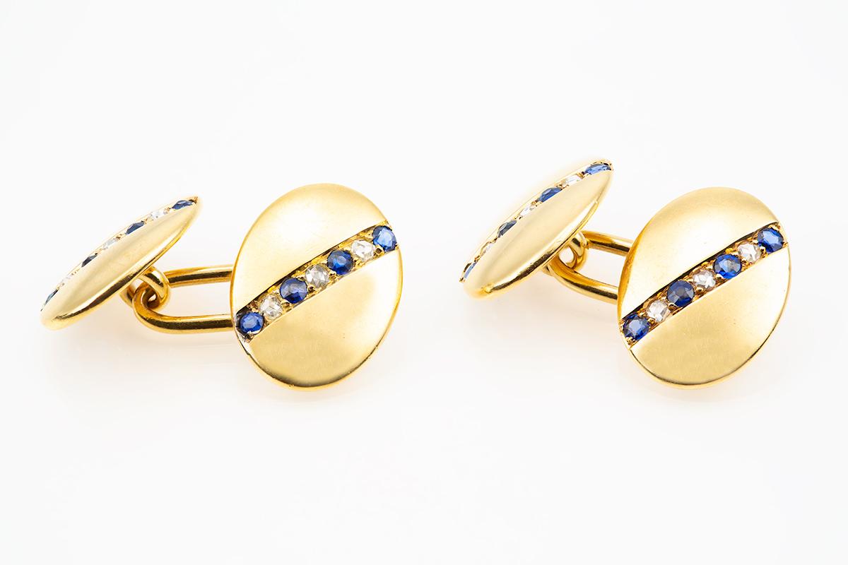 A heavy and finely made pair of double sided cufflinks in 18 carat yellow gold. Oval in shape and of plain form set with a diagonal line of alternating Ceylon sapphires and rose cut diamonds of good colour. Heavy quality and stamped 18ct to the