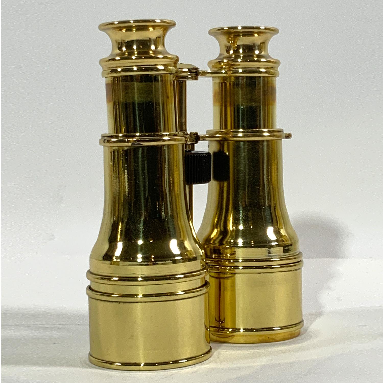 Exceptional pair of polished and lacquered English Marine binoculars. Rare amber filtered lenses. Geared focal knob. Clear crisp optics. Circa 1930.