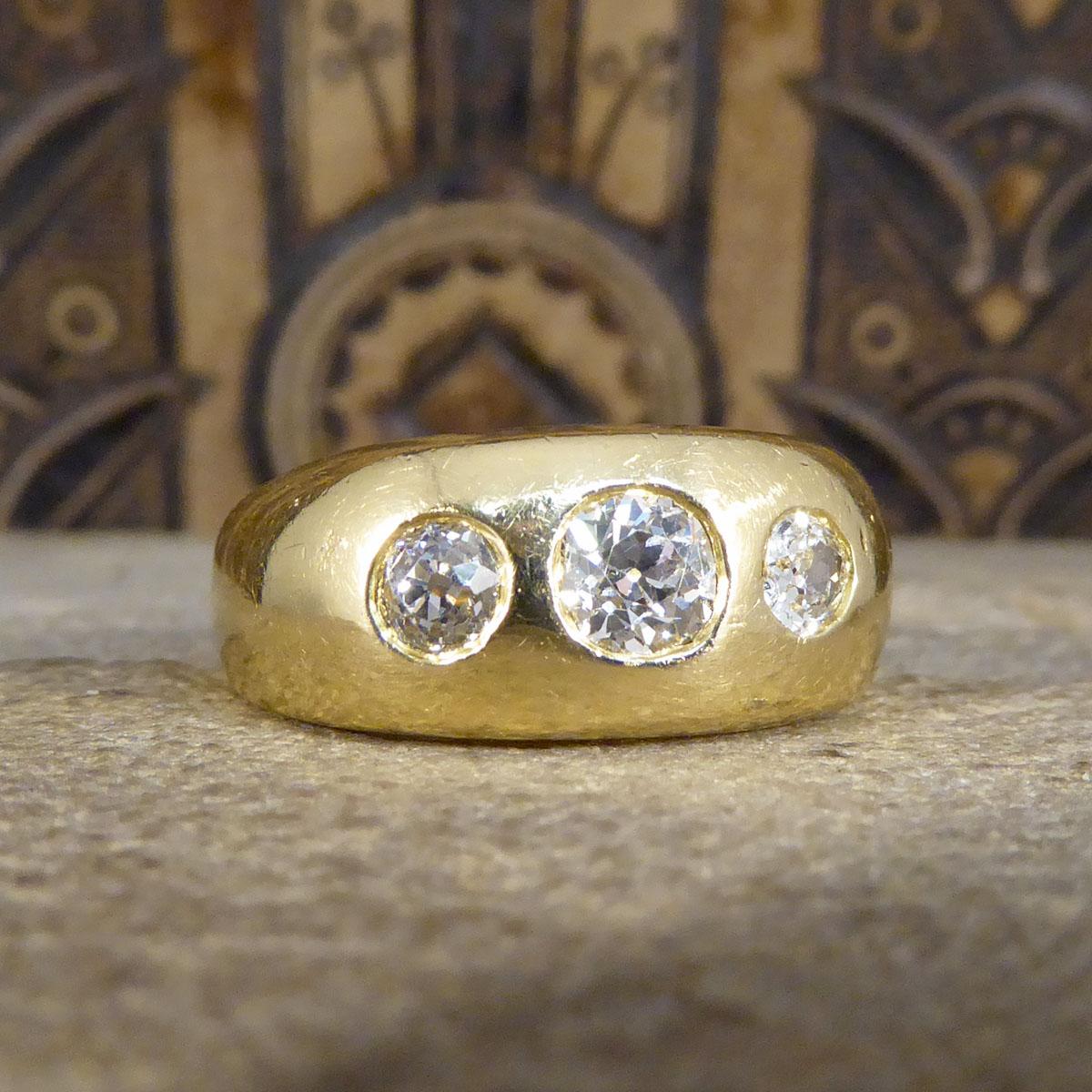 This antique ring has been hand crafted in the Late Victorian era and later fully hallmarked when it has likely been resized, which is why there is a later hallmark on the inner band. This gorgeous heavy quality three stone Diamond gypsy ring has a