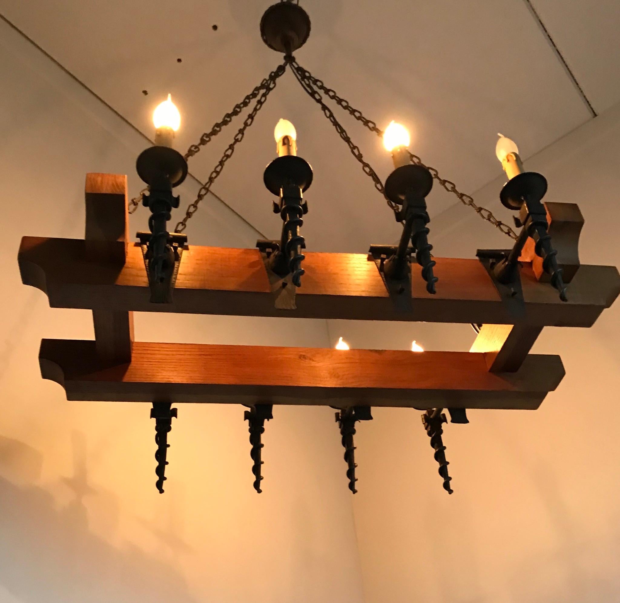 Large size and great shape, early 20th century light fixture. 

This perfectly handcrafted light fixture from 1910-1920 is another on of our recent great finds. The combination of the heavy and beautifully shaped oak beams and the hand forged,