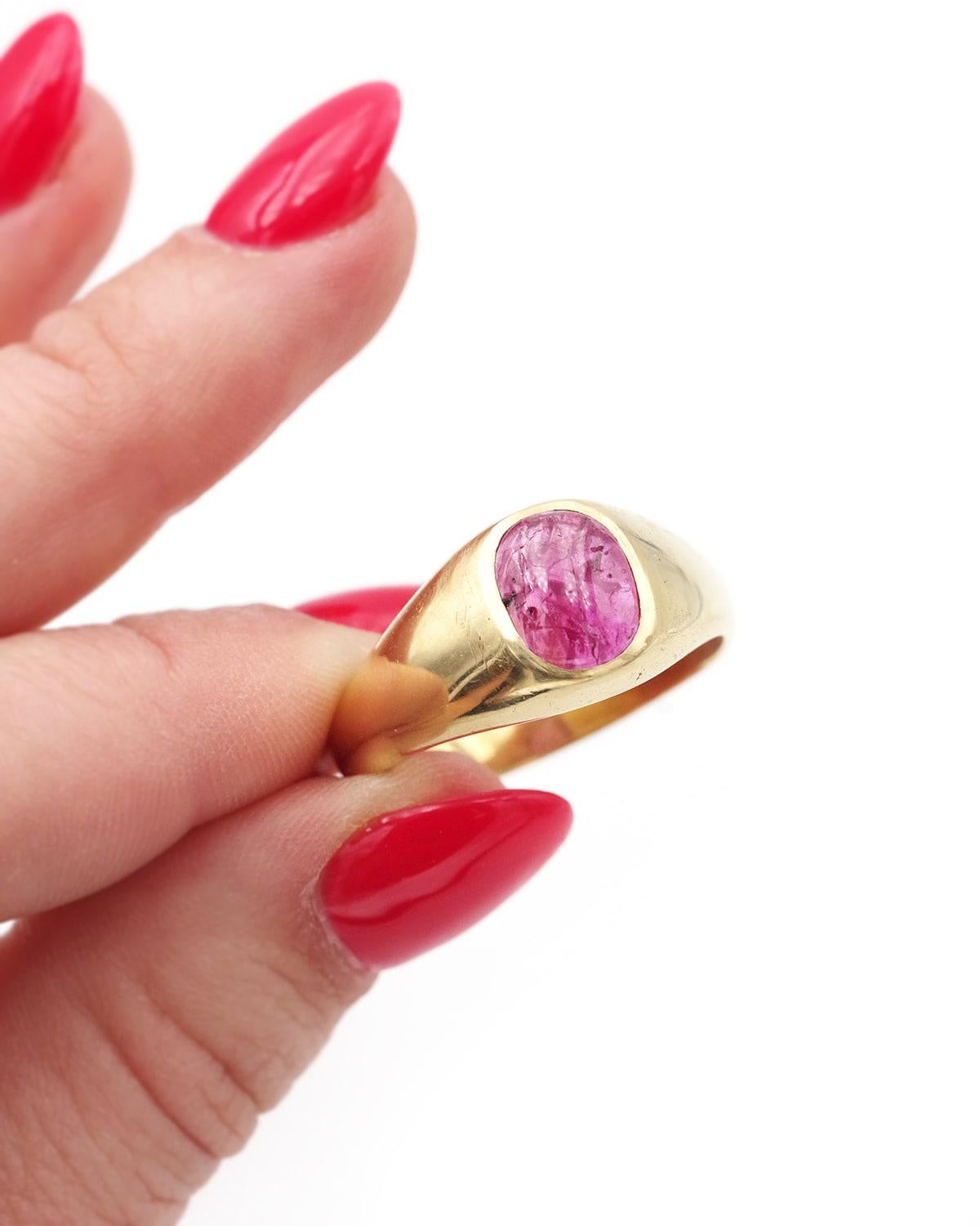 Solid ruby band ring in 18 karat. Large ring centered with a natural ruby cabochon weighing 1.86 carats, suitable for men or women. The ring is solid gold, the ruby has a deep pink color with darker shades inside. Ring from the 1960s,