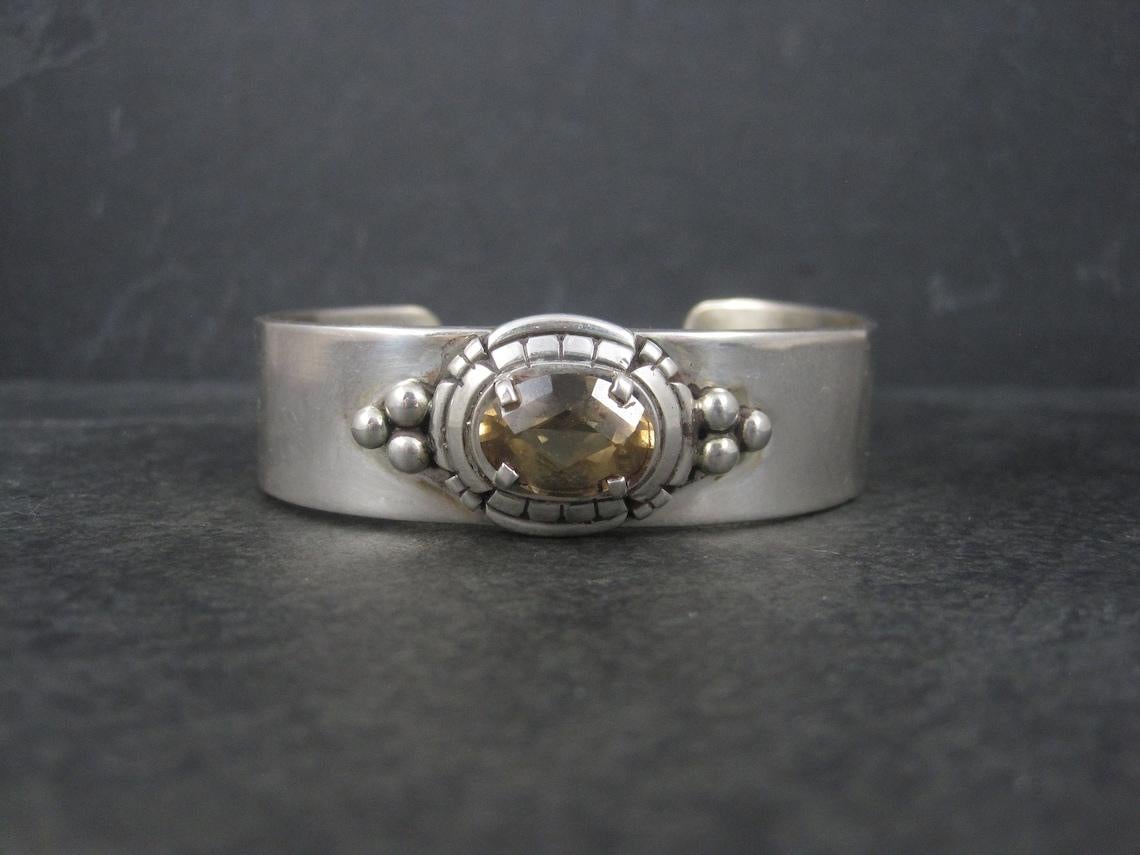 This gorgeous vintage Southwestern cuff bracelet is sterling silver with a 10x14mm citrine stone.

This cuff measures 3/4 of an inch wide.
it has an inner circumference of 6 1/2 inches, including the 1 inch gap.
Weight: 48.8 grams

Marks: