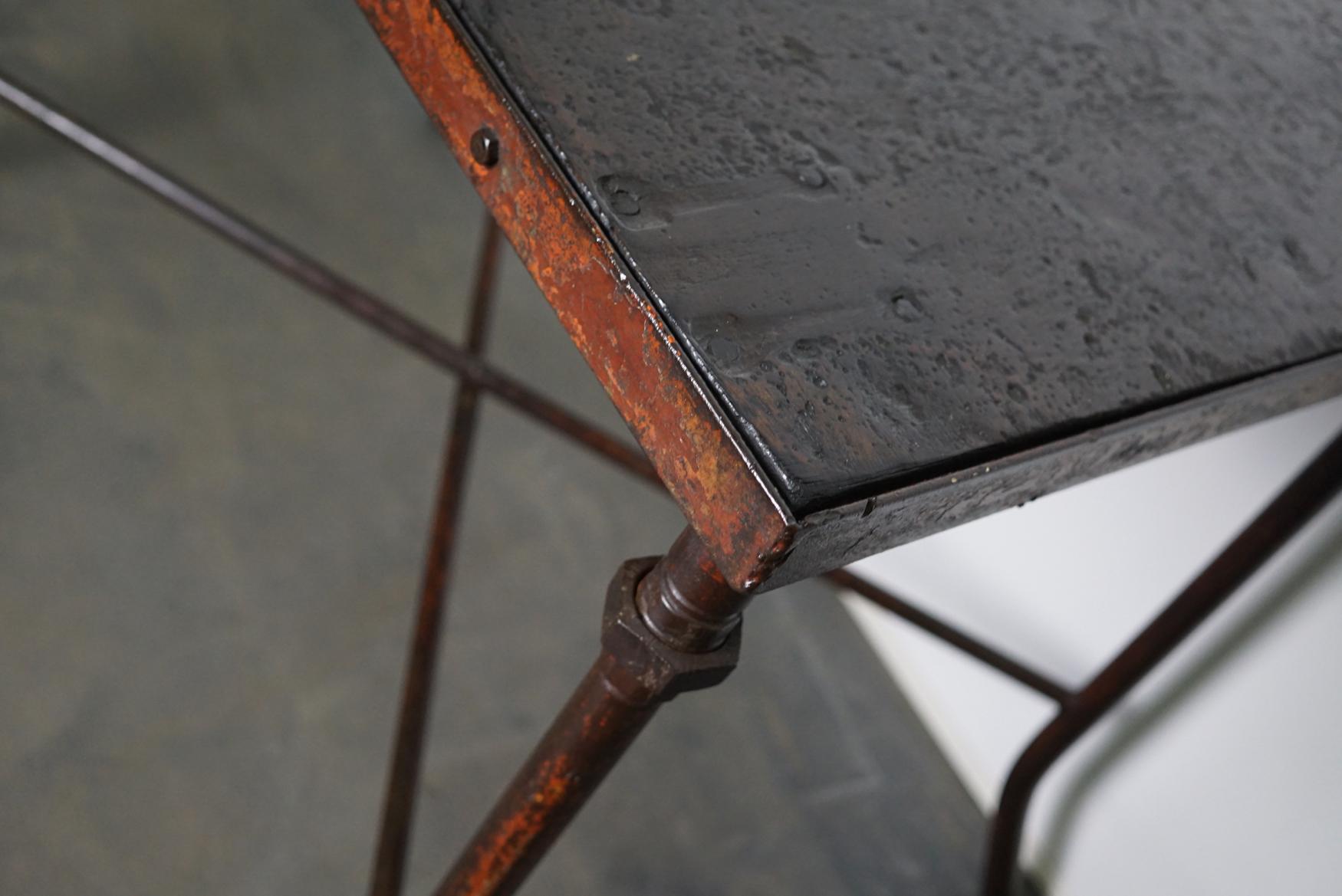 This steel workshop table was designed and made circa 1950s in Germany. It has a hardwood top and a steel frame.