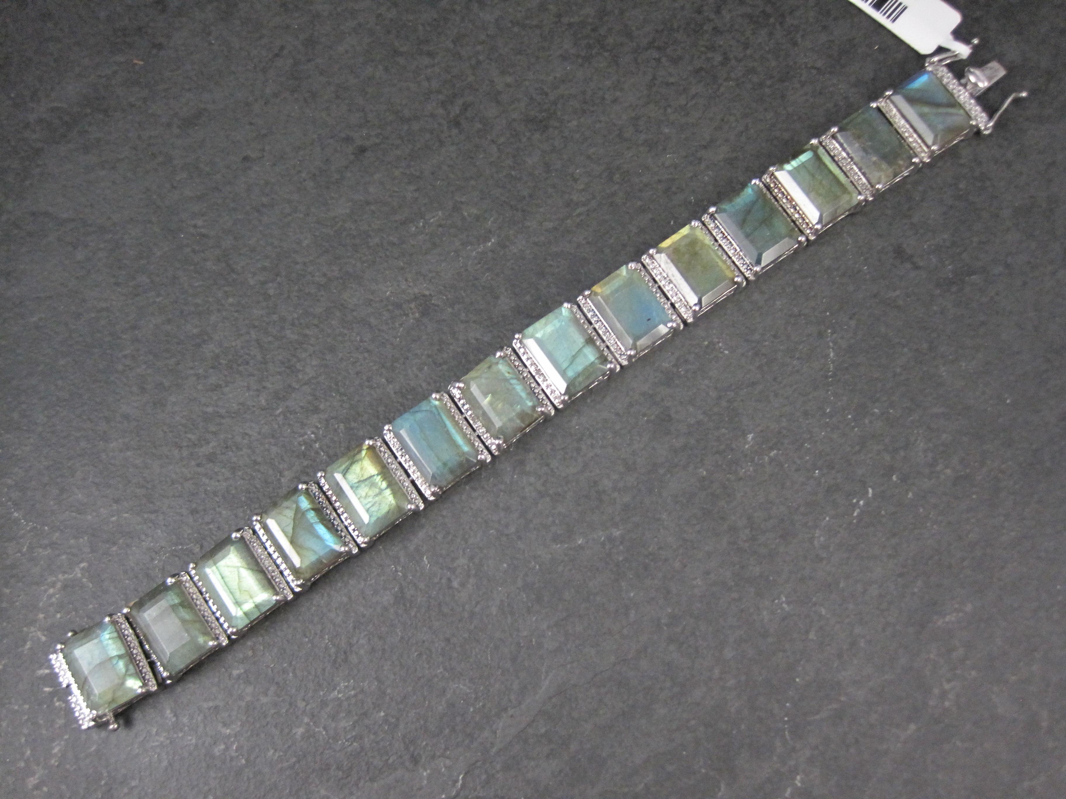 This gorgeous bracelet is sterling silver.
It features 14 stunning 10x14mm labradorite gemstones.
The box clasp bears a safety catch on each side.

Measurements: 5/8 of an inch wide, 7 1/2 wearable inches
Weight: 49 grams
Marks: 925, STS

Condition: