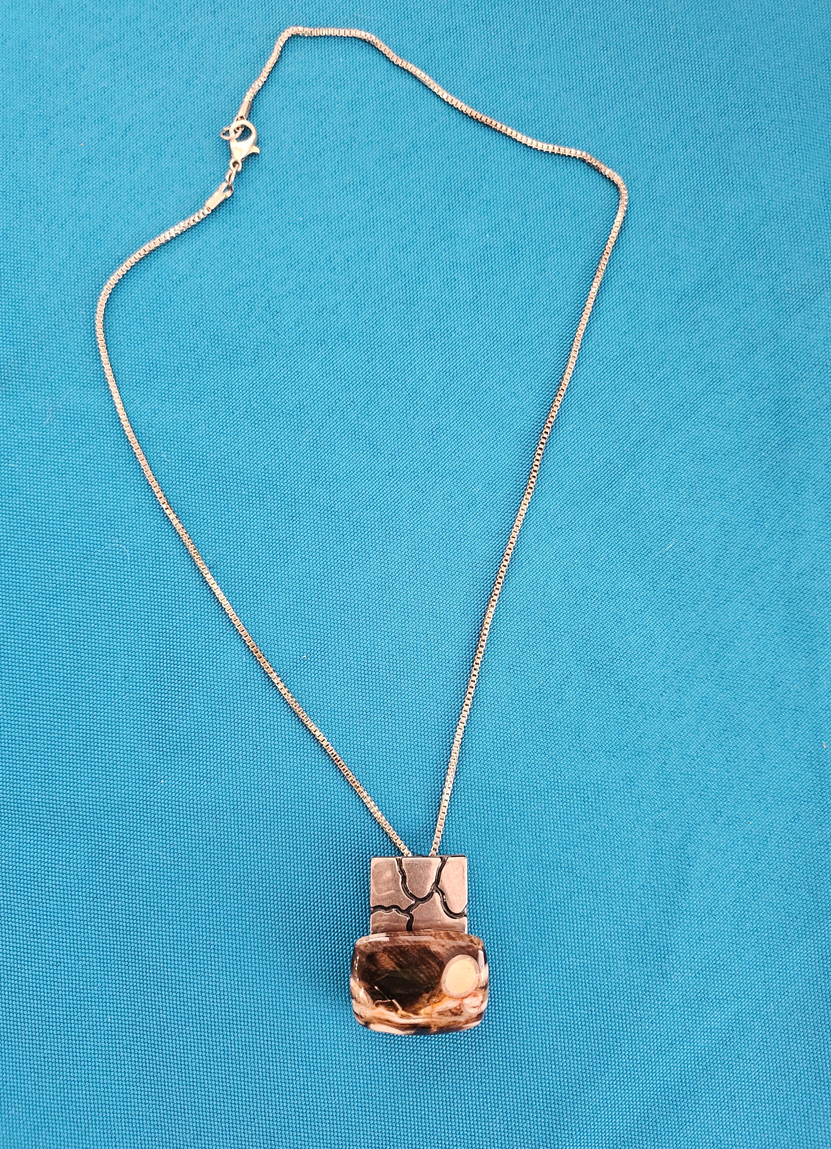 Heavy Sterling Silver Pendant Necklace with Semiprecious Stone, Stamped, Vintage.
This is a heavy and unusual sterling silver slide pendant, stamped on the back, with a semiprecious stone mounted on the silver.   The chain also appears to be silver