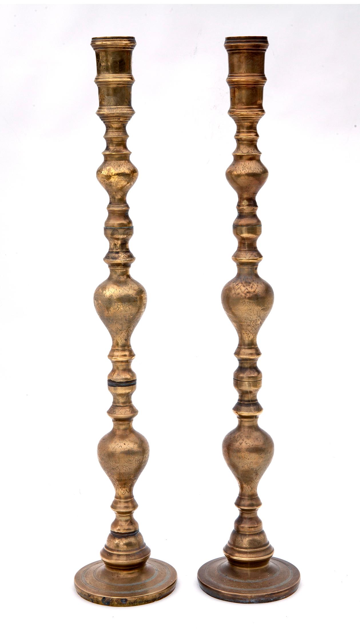 A pair of unusually tall  Early 20th century brass candlesticks with fine etching.

