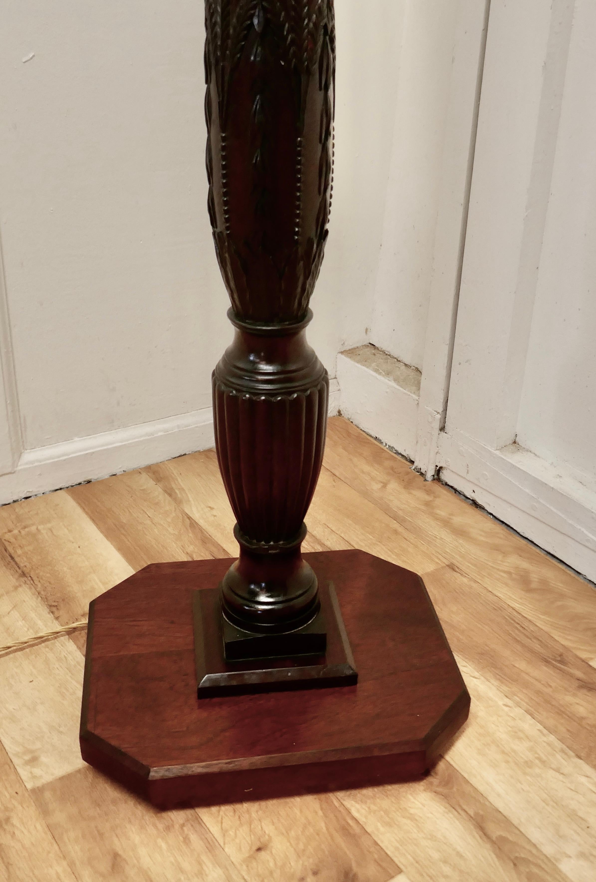 Heavy Turned Mahogany floor standing or standard lamp

This is an attractive piece in polished mahogany, the lamp stands on a square base, the upright is in the form of a very thick shaped and fluted column with a superbly carved decoration at the