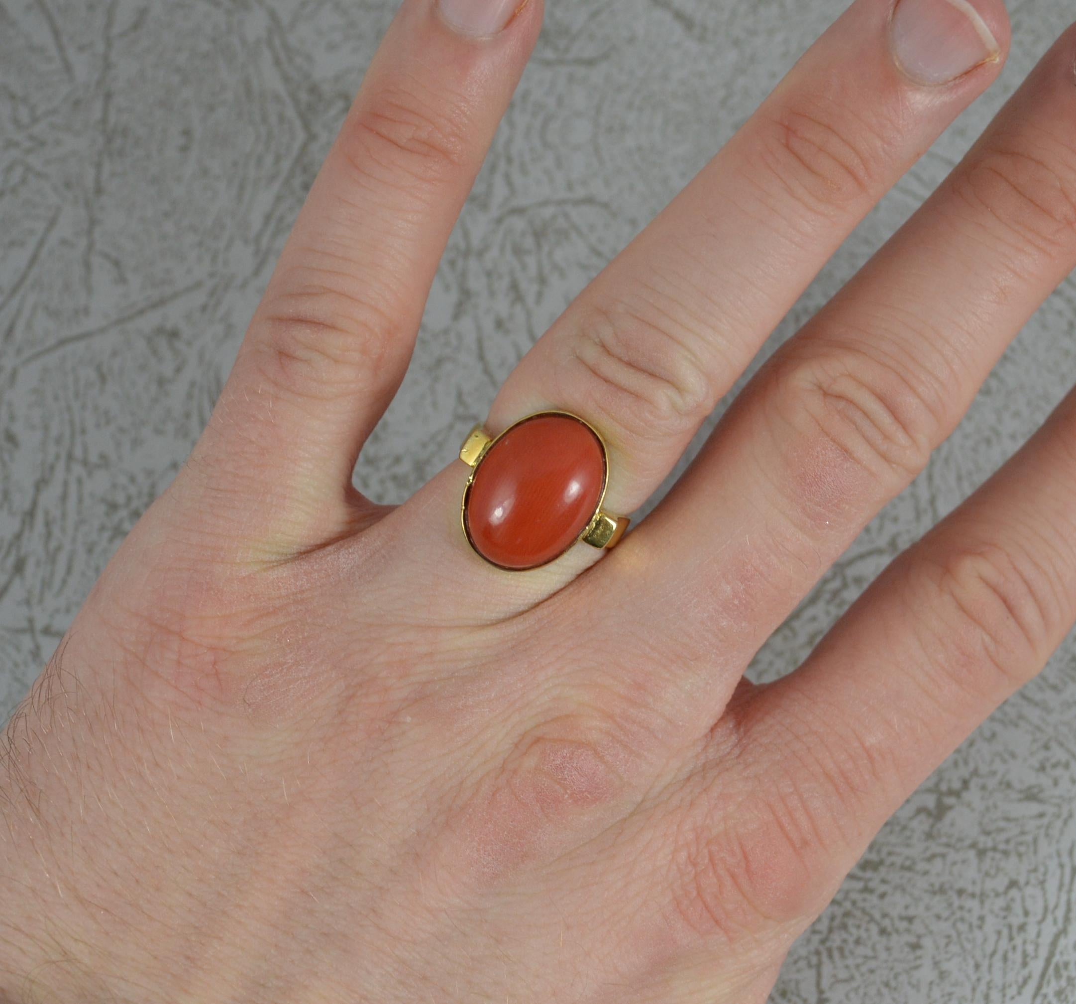 A beautiful vintage retro ring.
Solid 18 carat yellow gold example.
Designed holding one single oval shaped coral. 12mm x 16mm coral. 
Made with split shoulders and a fine plain gold head setting.

CONDITION ; Very good. Clean, solid band. Securely