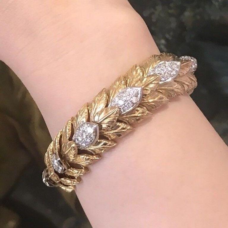 Heavy Vintage Carved Leaf Diamond Bracelet in 18k Yellow Gold

Wide Heavy Vintage Bracelet features Carved Leaf over-lapping Links with Pave Diamond Sections in the center set in 18k Yellow Gold. The bracelet is secured by a tongue clasp with