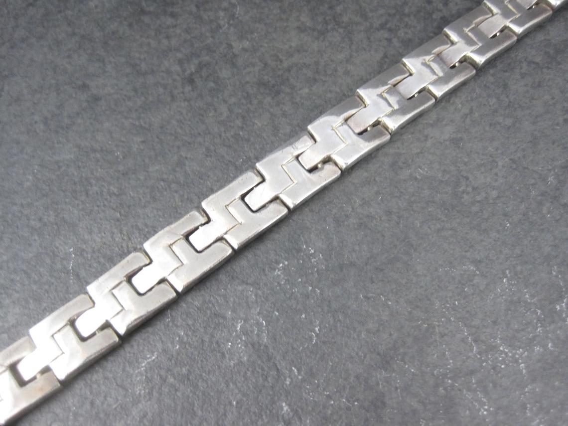 This beautiful vintage mexican bracelet is sterling silver.

The gorgeous bracelet measures 7.5 inches when clasped.
It is hallmarked: Mexico, 925, TR-111, J - The J is actually a partial hallmark Its meant to be JRD. .
It is 11mm thick and weighs