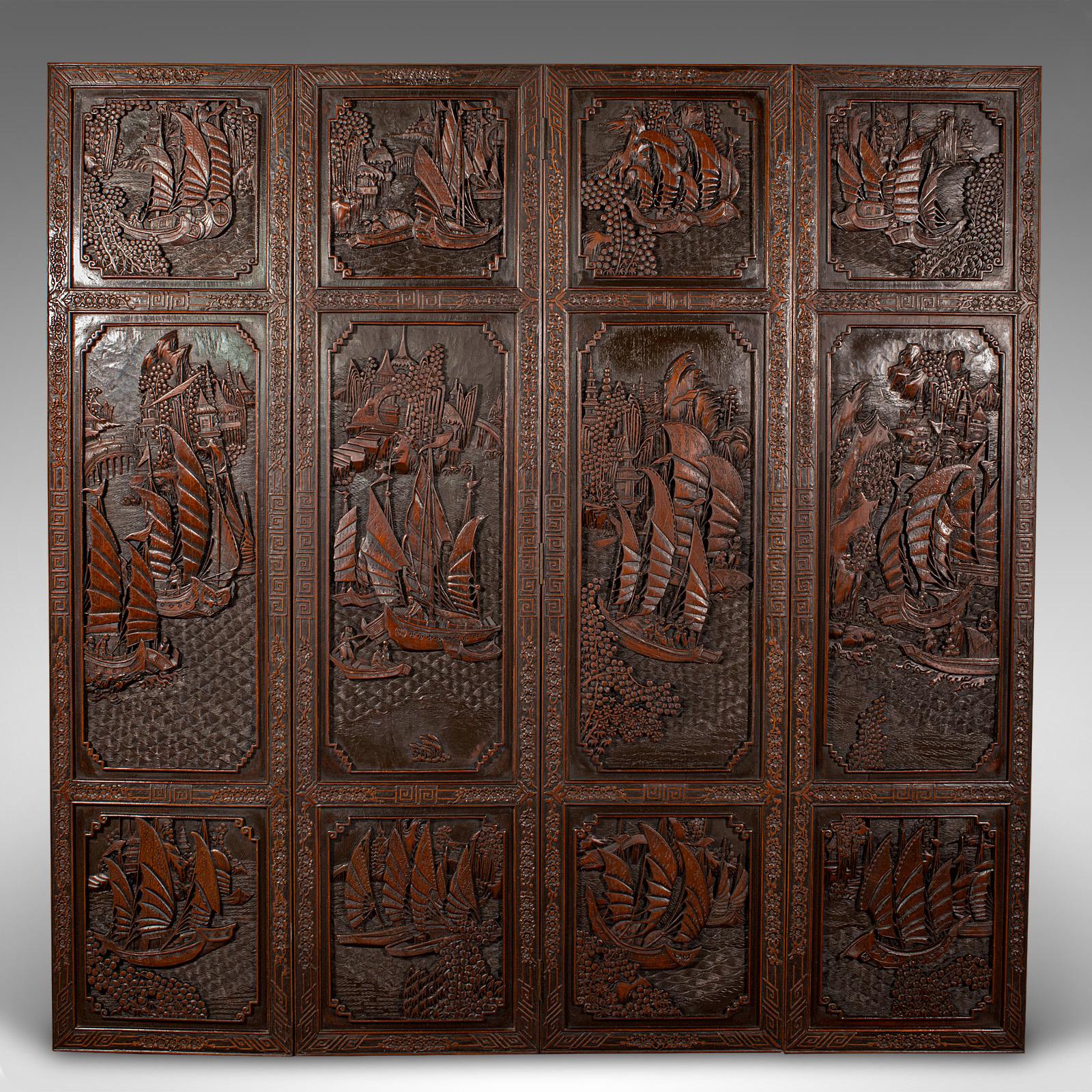 This is a heavy vintage privacy screen. A Chinese, carved mahogany 4-fold room divider or wall panel dating to the late Art Deco period, circa 1950.

Substantial and eye-catching with wonderful carved detail
Displays a desirable aged patina. and in