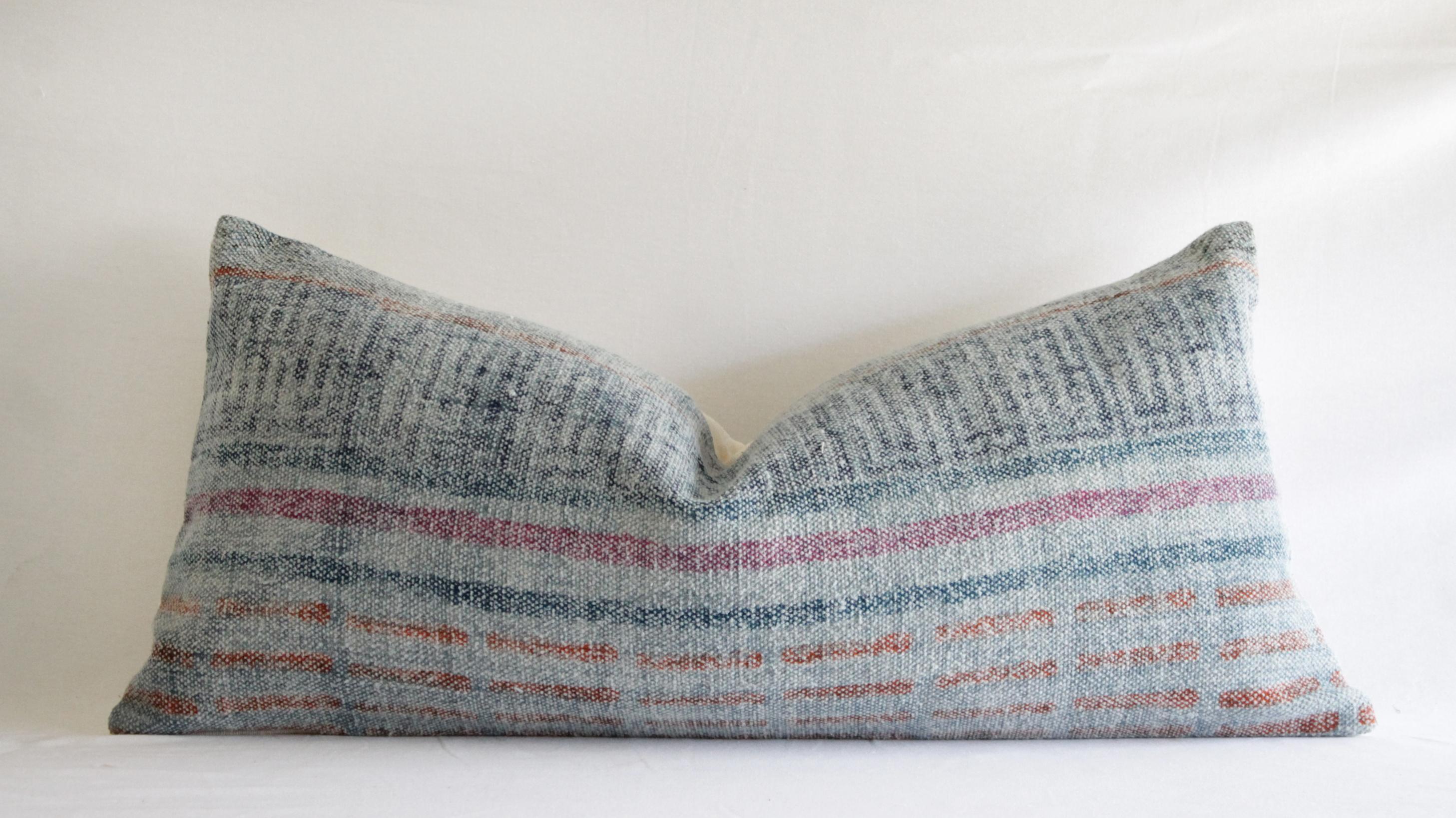 Heavy woven cotton accent lumbar pillow
soft pale blue grey background with accents of indigo, ocean blue, faded red and orange stripes.
Measures: 13.5