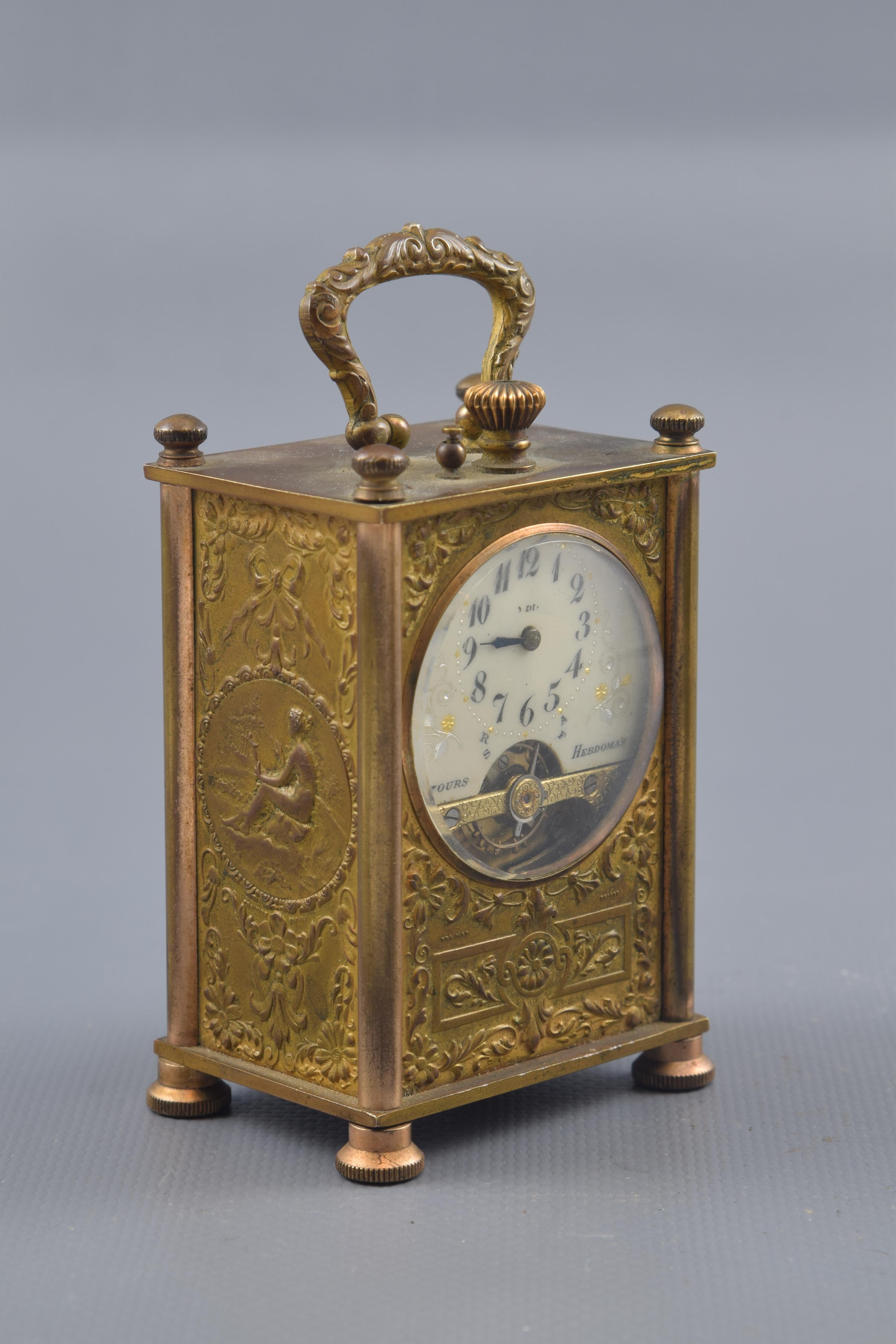 Hebdomas 8 jours carriage watch. Bronze, etc. France, circa 1900. 
8 day rope with markings on fronts (Frainier Depose), upper part (Depose) and signature on dial (8 jours Hebdomas).
 Rectangular box table clock resting on circular legs with a
