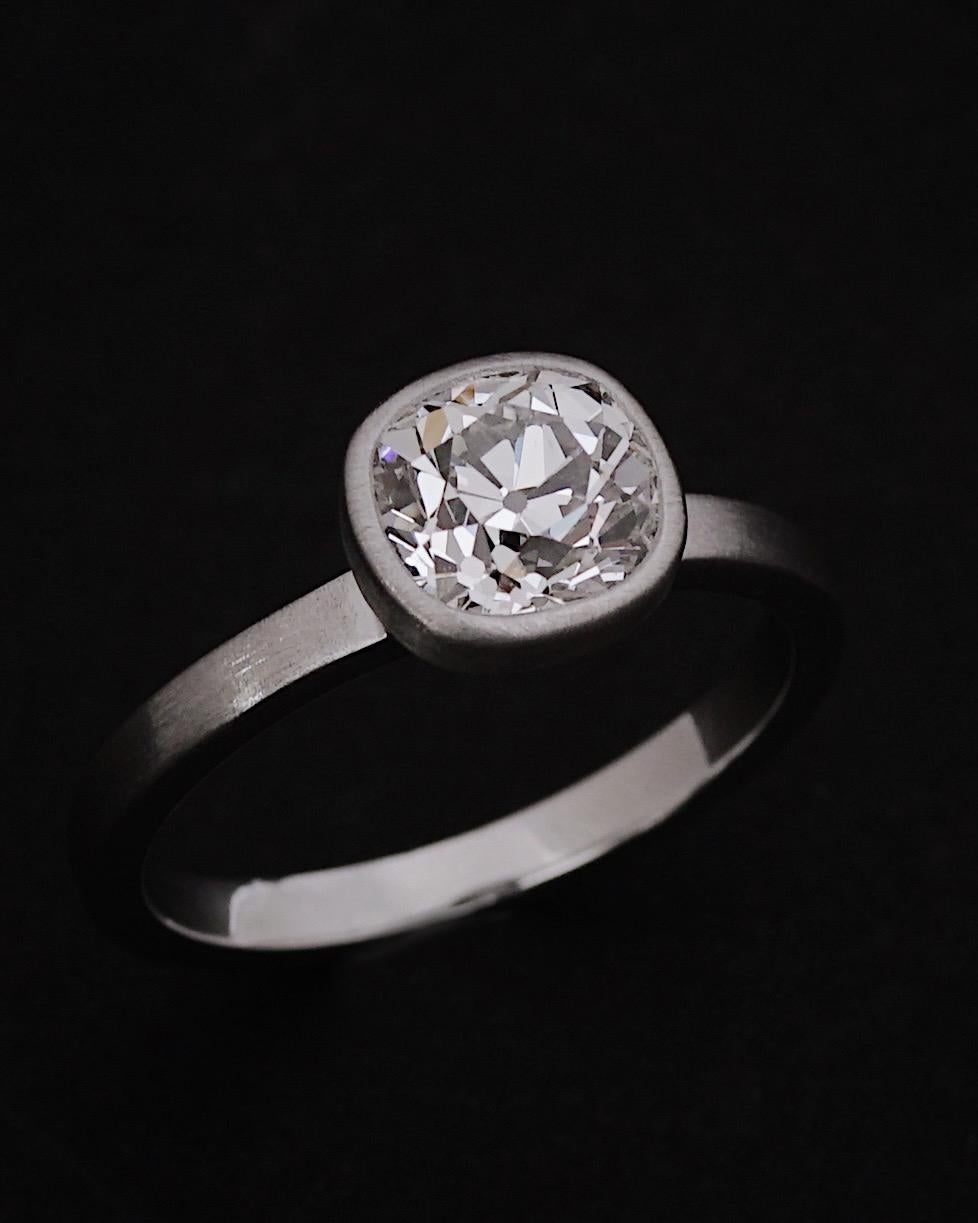 Old mined diamonds are forever. 
This 1.50cts H/VS2 (CERT) Old Mined Cushion Diamond is beautifully set by Hecate with a matt close setting on the outside and brilliant on the side and inside the ring.
The stone, with its H color reveals a strong