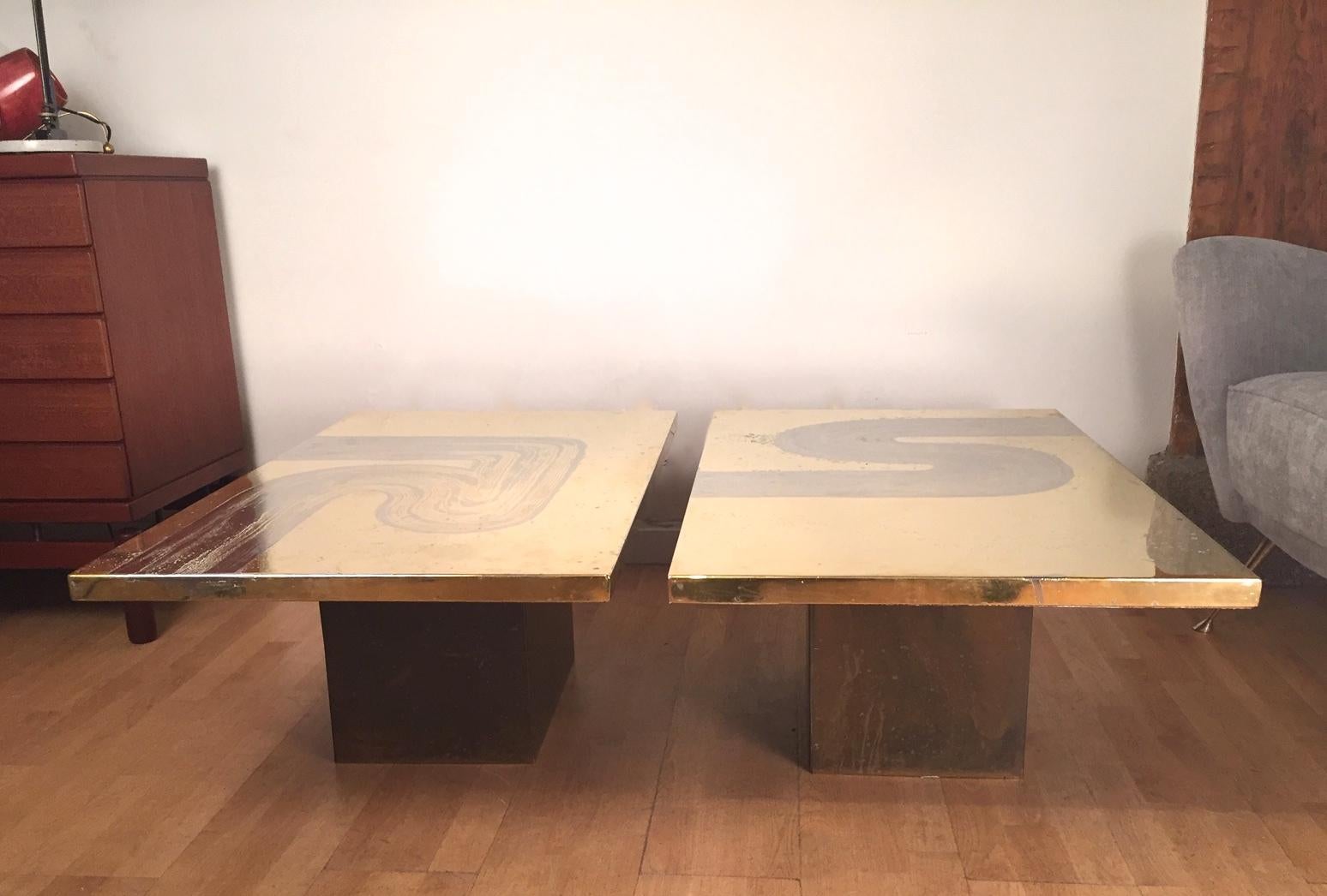 A pair of patinated brass coffee tables on enameled metal pedestals. Designed in 1070 by Belgian artist Christian Heckscher for Propoama. Signed 