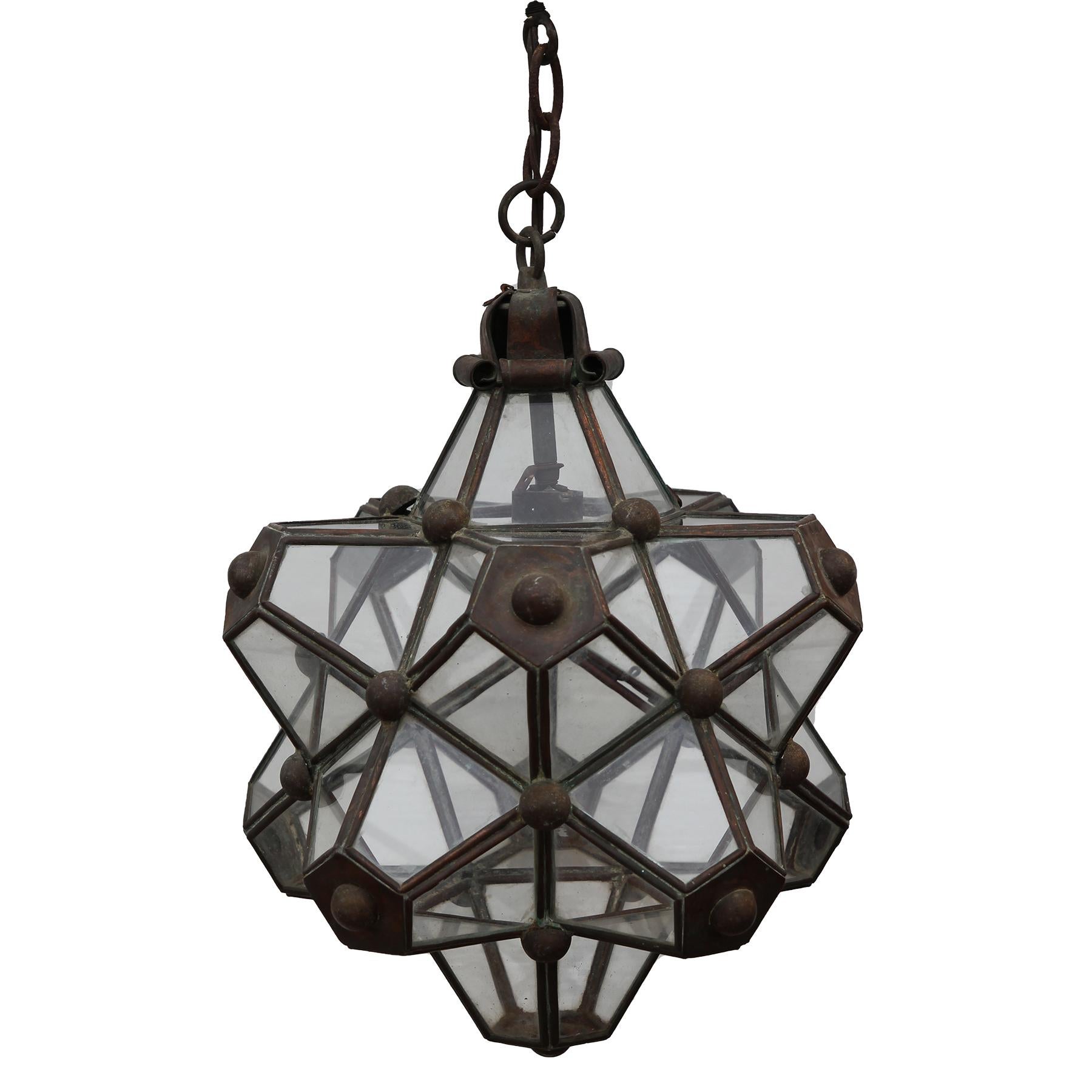 Hector Aguilar copper and brass architectural star light fixture that was created in 1945 and is in great condition. The framing of the light fixture incorporates copper and brass elements that hold each piece of glass.