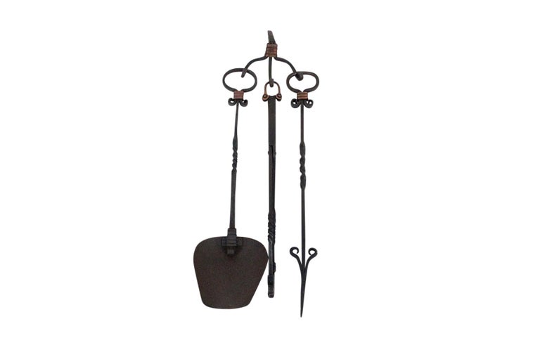 Rare fireplace tool set by Hector Aguilar hand forged in wrought iron and copper. Set includes wall mount, ash shovel, poker, and tongs. Signed with artist's cipher and Taxco mark.