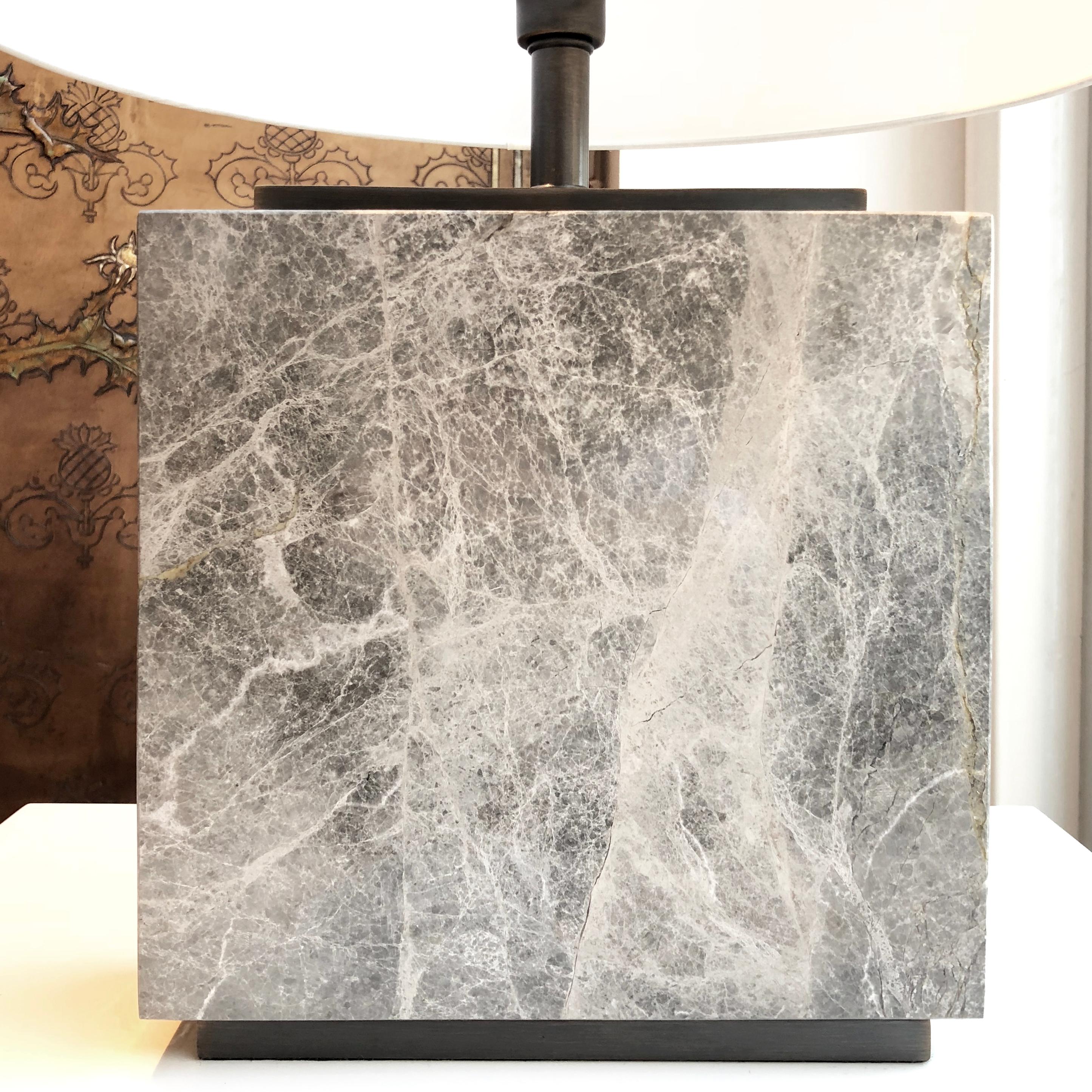 Elegant marble table lamp with bronzed detailing. The structure of this lamp is made from grey marble with a bronzed plinth on the top and bottom. Also available in white or black marble. Comes with additional bronzed detailing on request. Lampshade