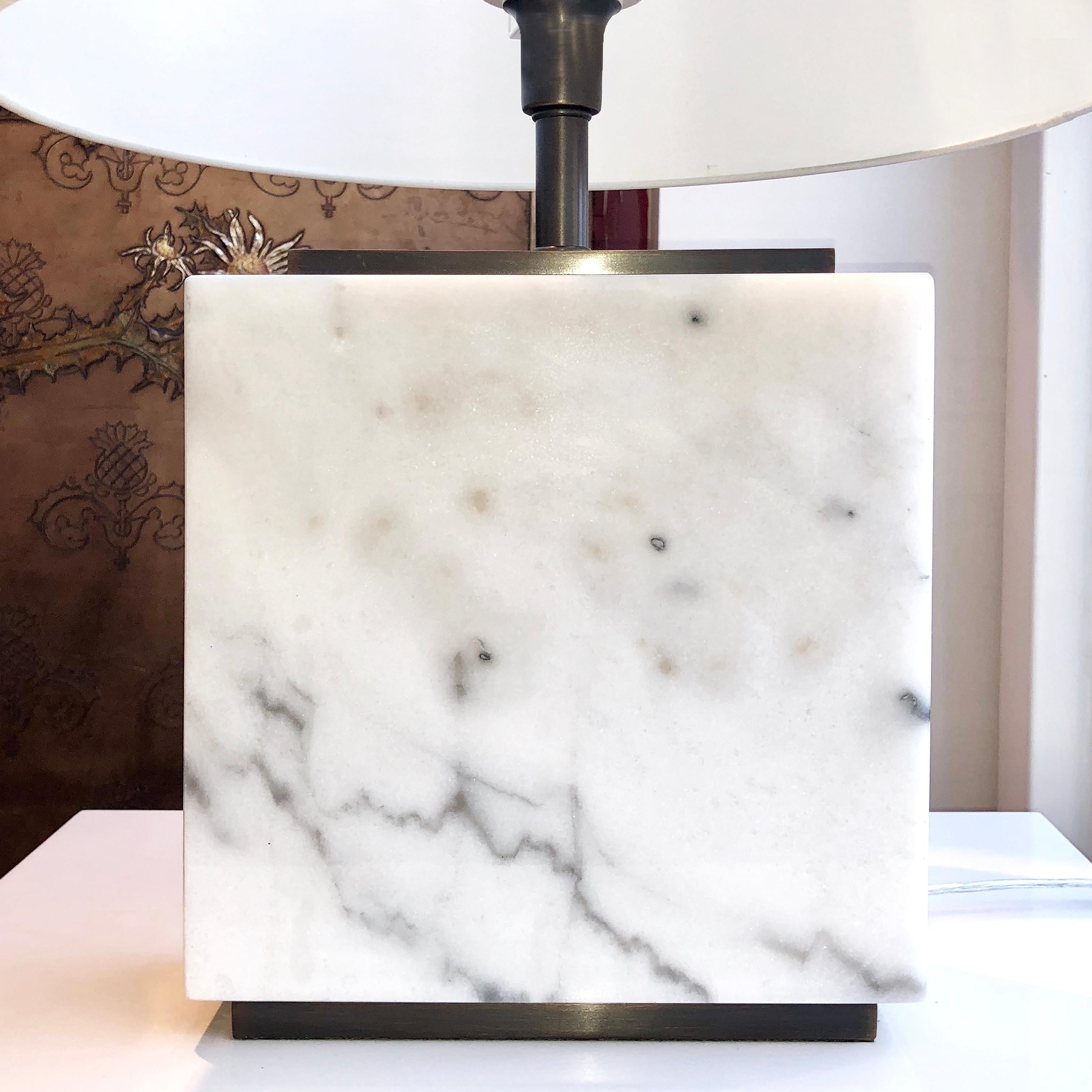 Elegant marble table lamp with bronzed detailing. The structure of this lamp is made from white marble with a bronzed plinth on the top and bottom. Also available in grey or black marble. Comes with additional bronzed detailing on request. Lampshade