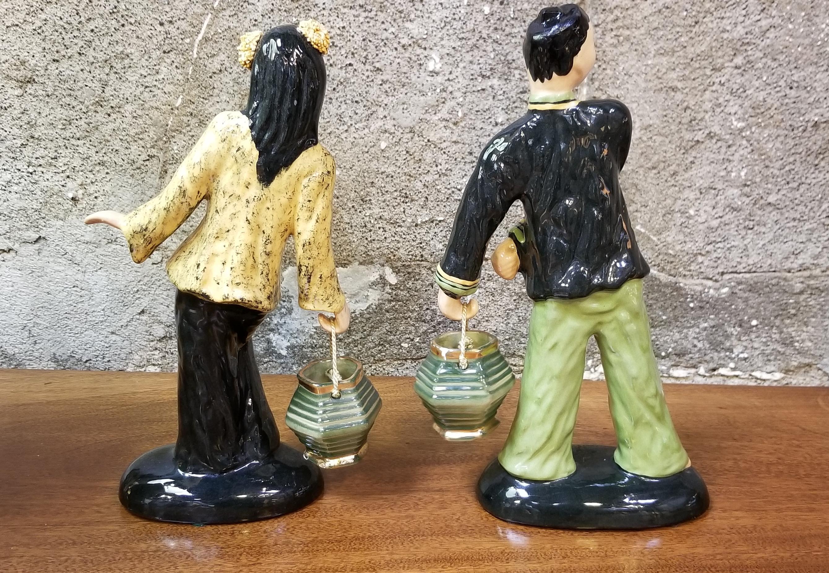 A signed pair of Hedi Schoop green, black and yellow oriental male and female figures with baskets, circa 1950s.

Hedi Schoop
One of the designers at the forefront of this era of Mid Century ceramic design was Hedi Schoop. Having fled Europe in 1933