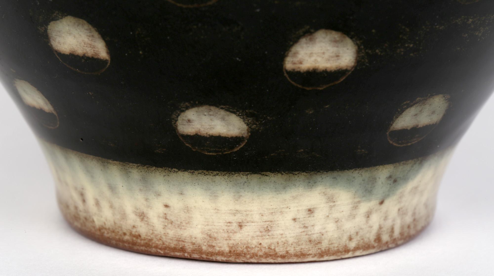 Stylish, probably Art Deco, German studio pottery vase decorated in black and white patterned glazes by Hedwig Bollhagen (German, 1907-2001). This lovely red earthenware vase stands on a narrow round unglazed foot rim with a recessed base and has a