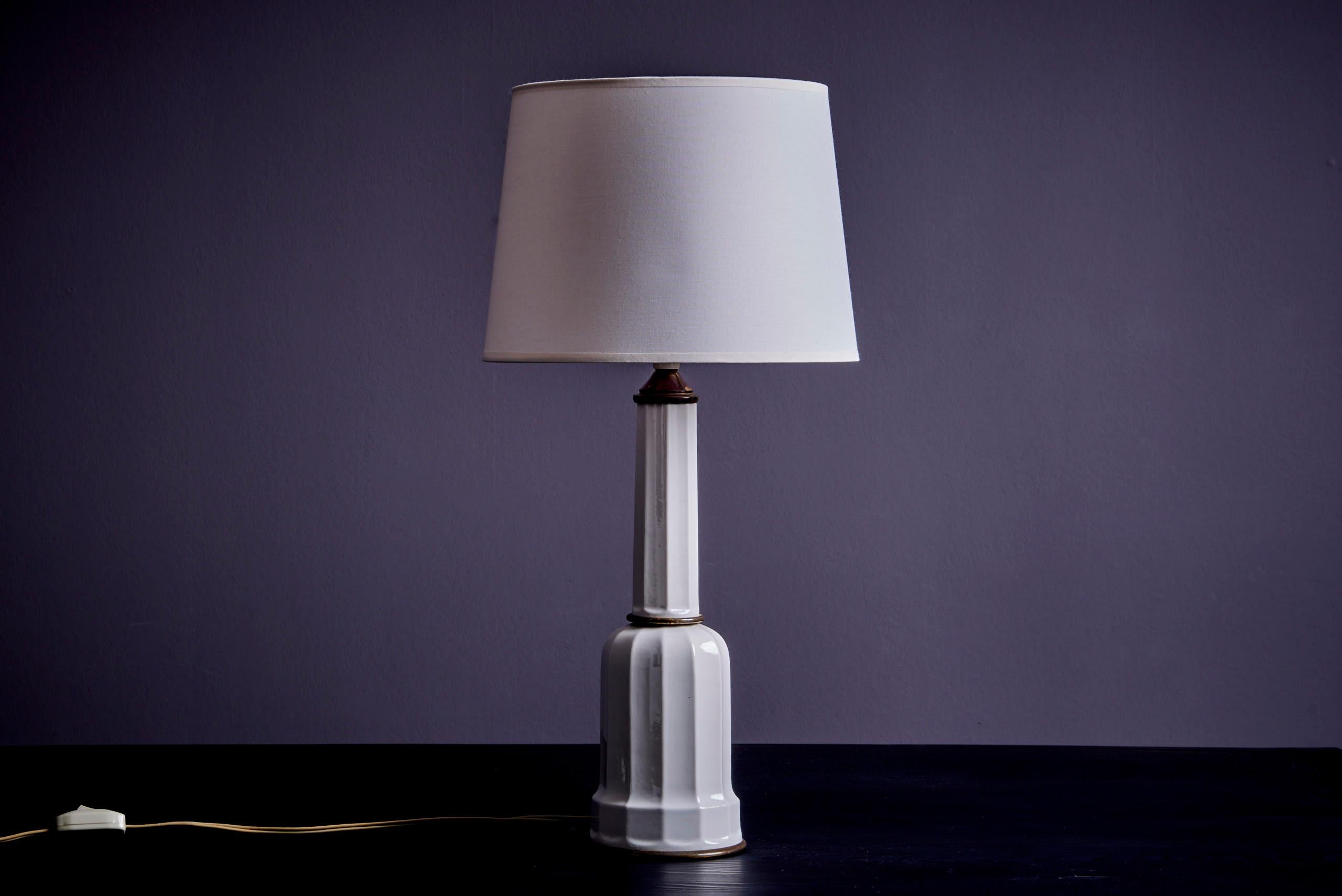Large Heiberg table lamp made of porcelain and brass by Søholm. Crafted from white glazed porcelain, this lamp features elegant patinated brass accents. The Heiberg name traces back to a 1830s painting by Wilhelm Marstrand, depicting the Heiberg