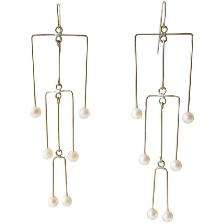 Pearl and brass kinetic mobile earrings created by Heidi Abrahamson of Phoenix, Arizona.  Earrings have 14k gold filled ear hooks and measure 4